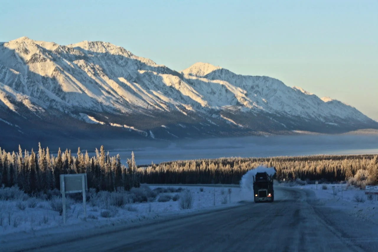day seven---truck on road with high mountains.jpg