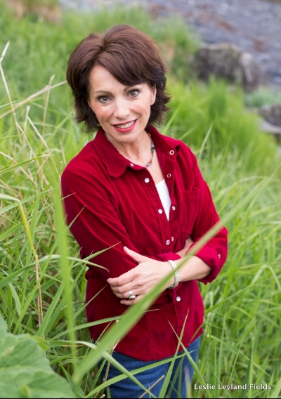 Leslie in red standing in green grass.jpeg