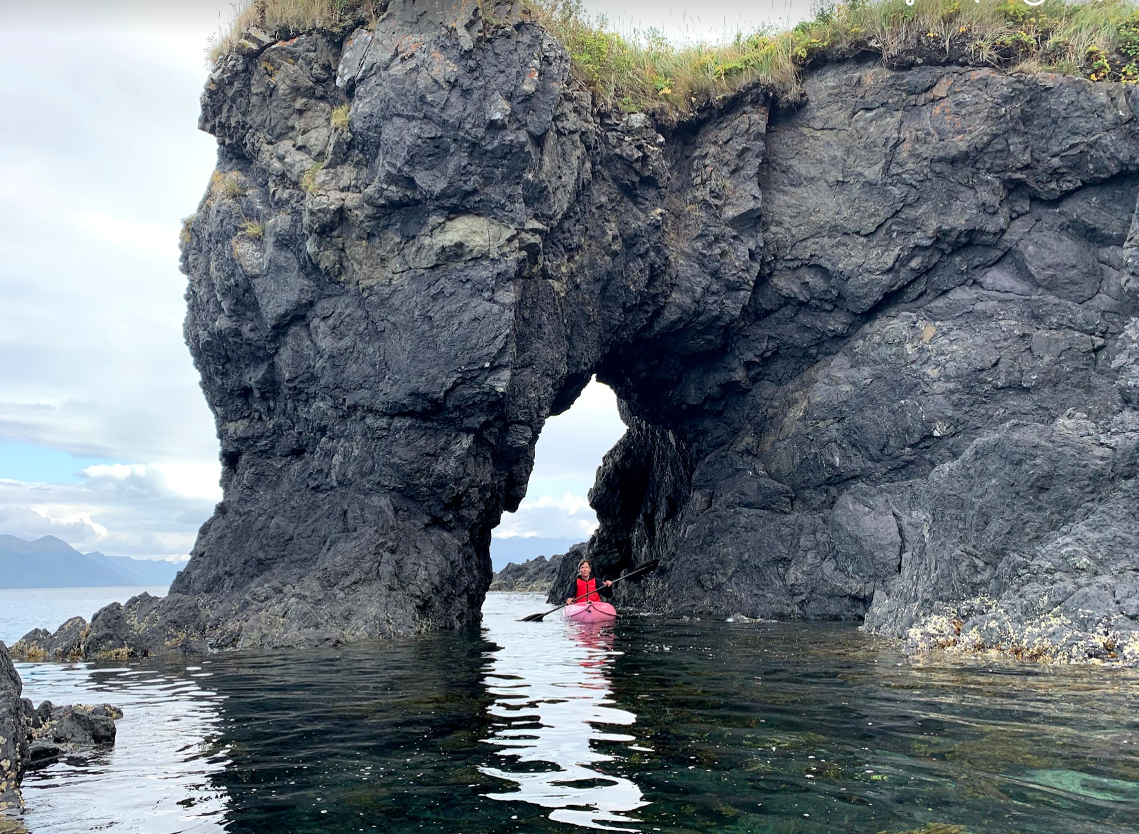 HIWW 2019 Robyn in kayak through arch.png