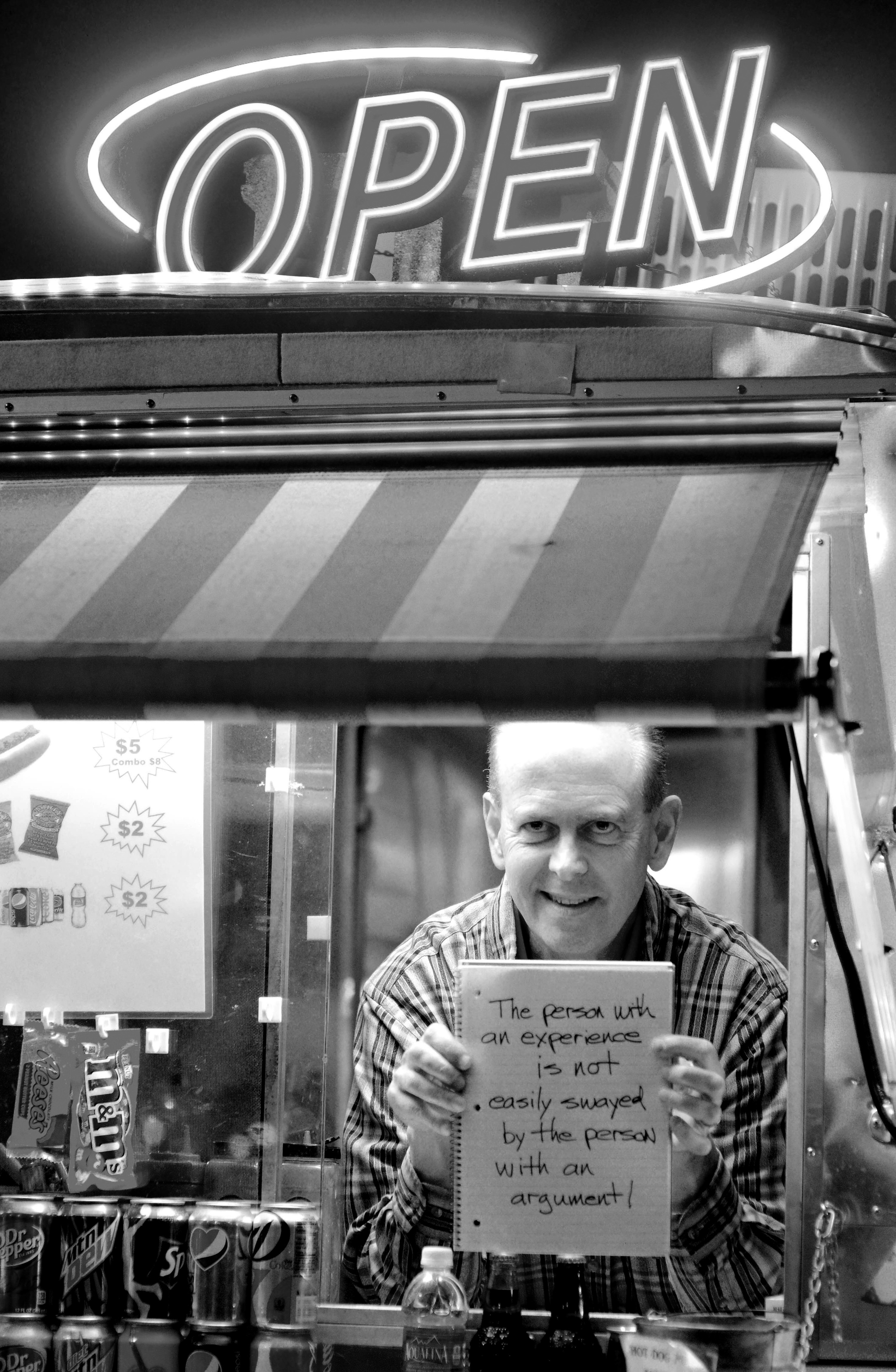  A food truck vendor holds up his favorite quote on the streets of downtown Nashville.&nbsp; 