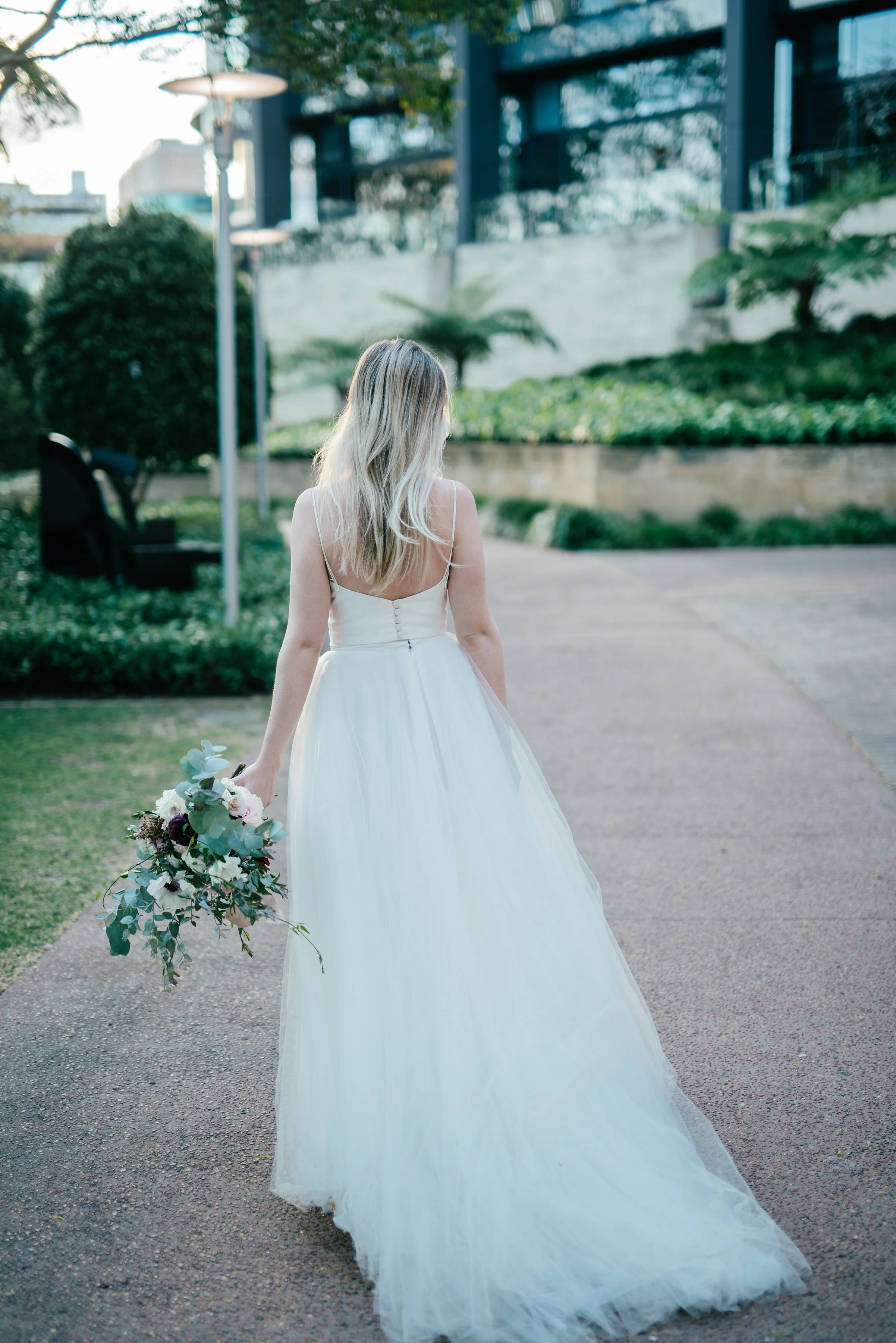 Model Courtney wears a Karen Willis Holmes gown with simple bodice and full tulle skirt finished with lace.