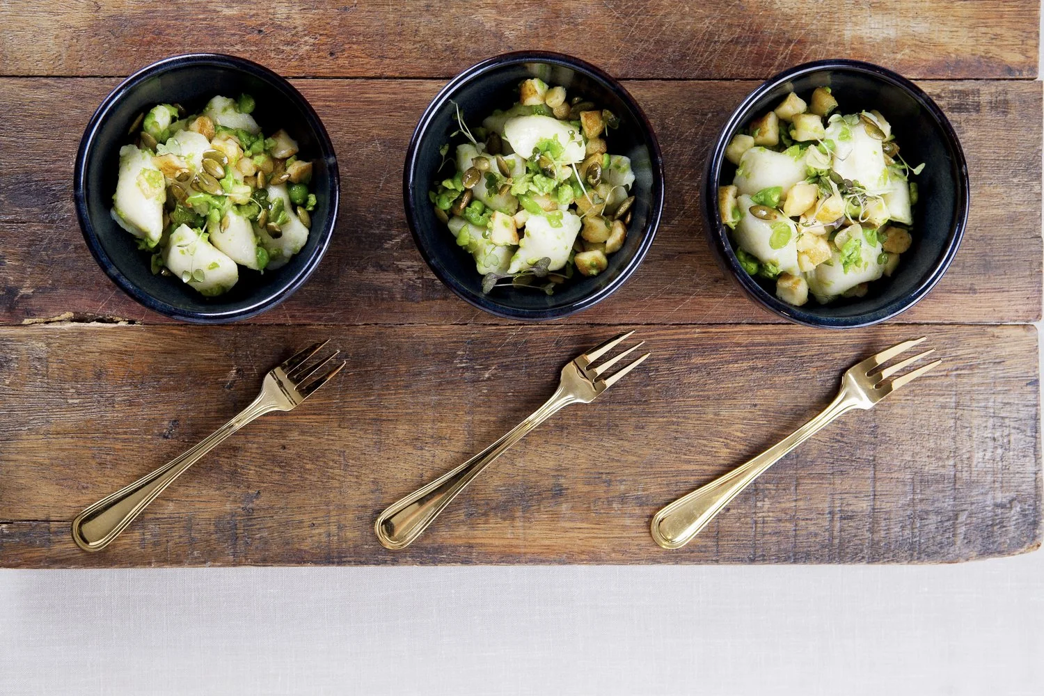 Gnochhi with peas, broad beans, haloumi & pumpkin seeds