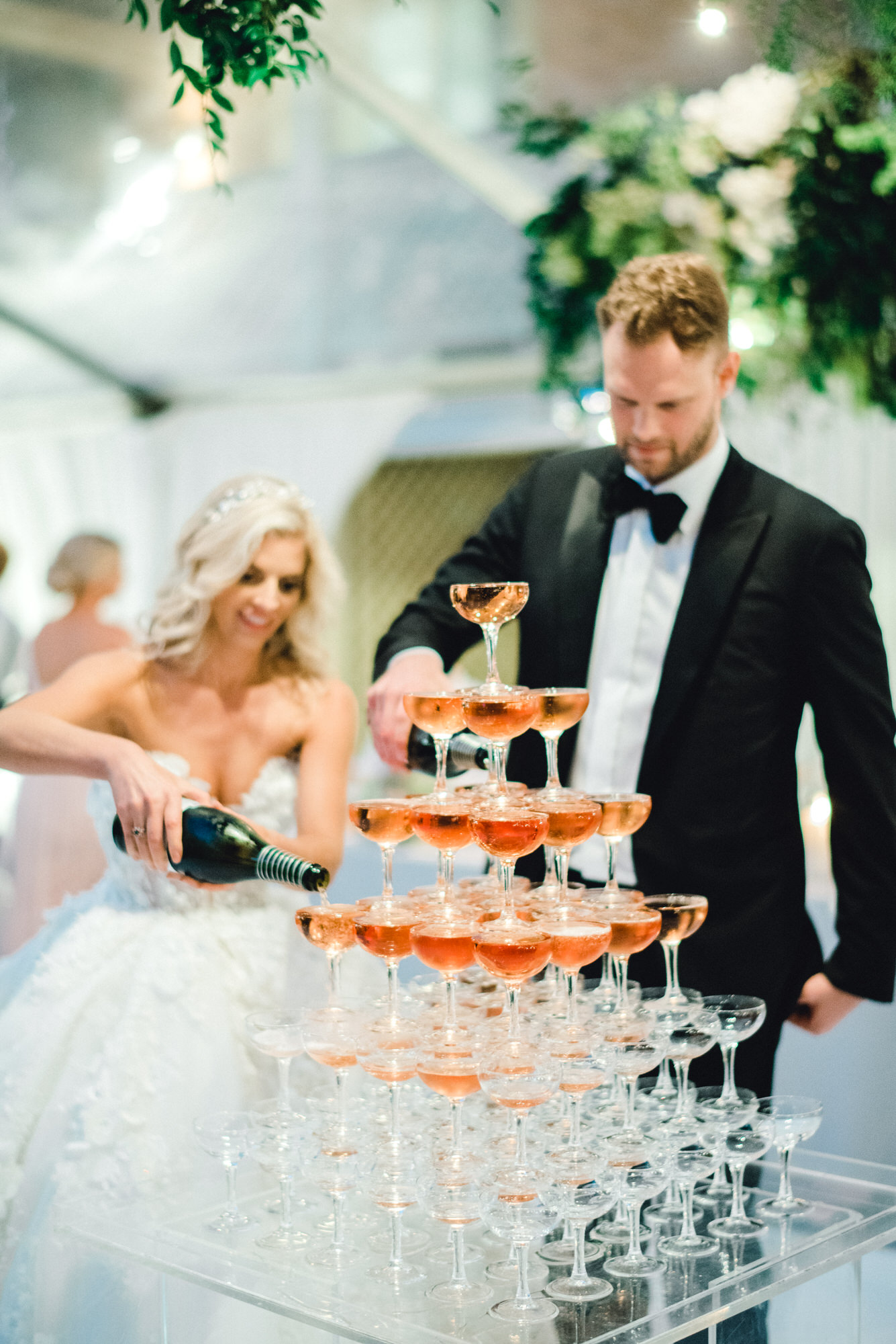 CHAMPAGNE FLOWING | One of their favourite touches was the Champagne tower they had ready at the beginning of the reception. "When Chris and I entered the reception, we poured the champagne into it and then had it served to our guests."
