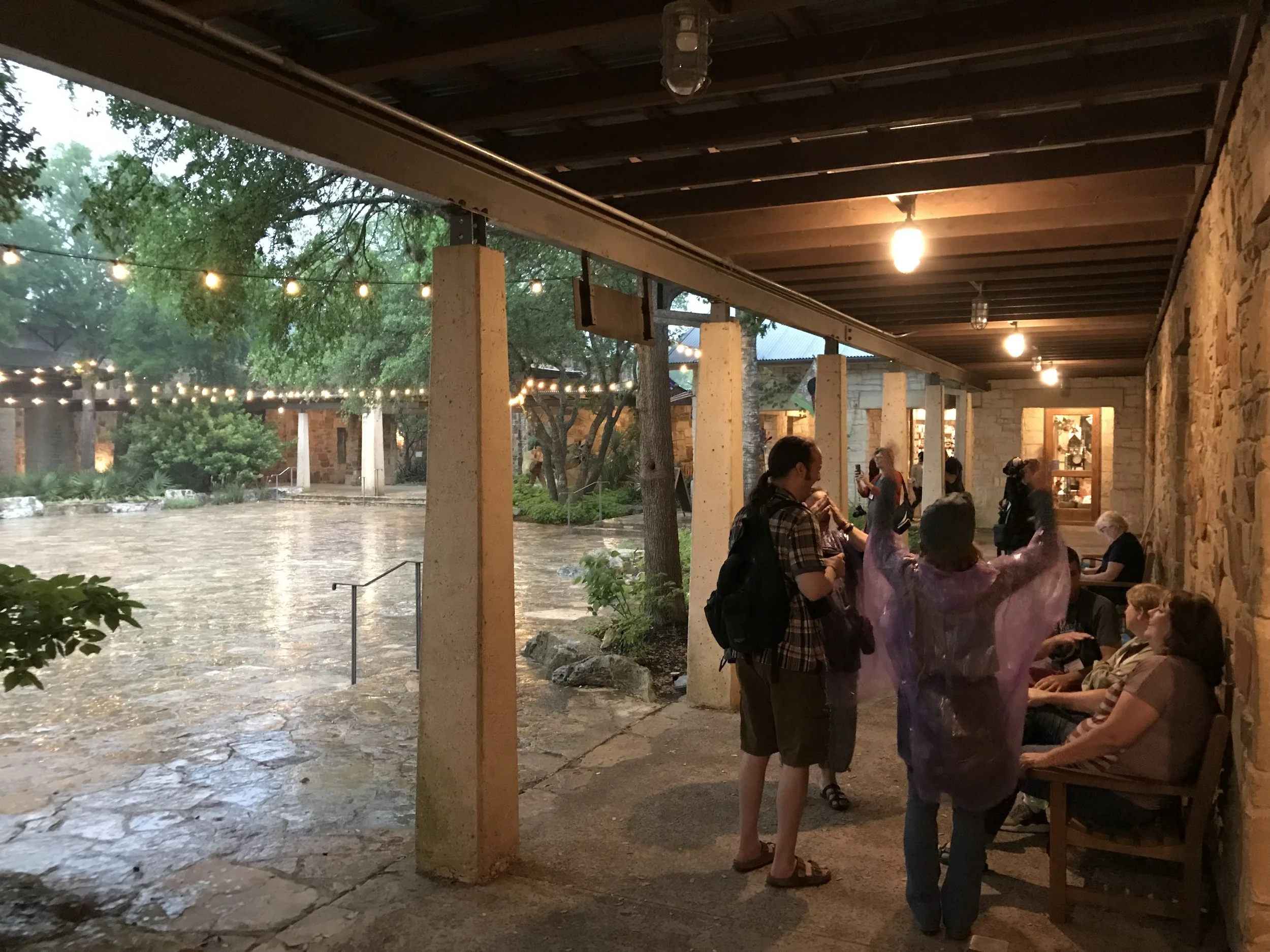 Our group seeking shelter from the rain, under the central courtyard's porticos.