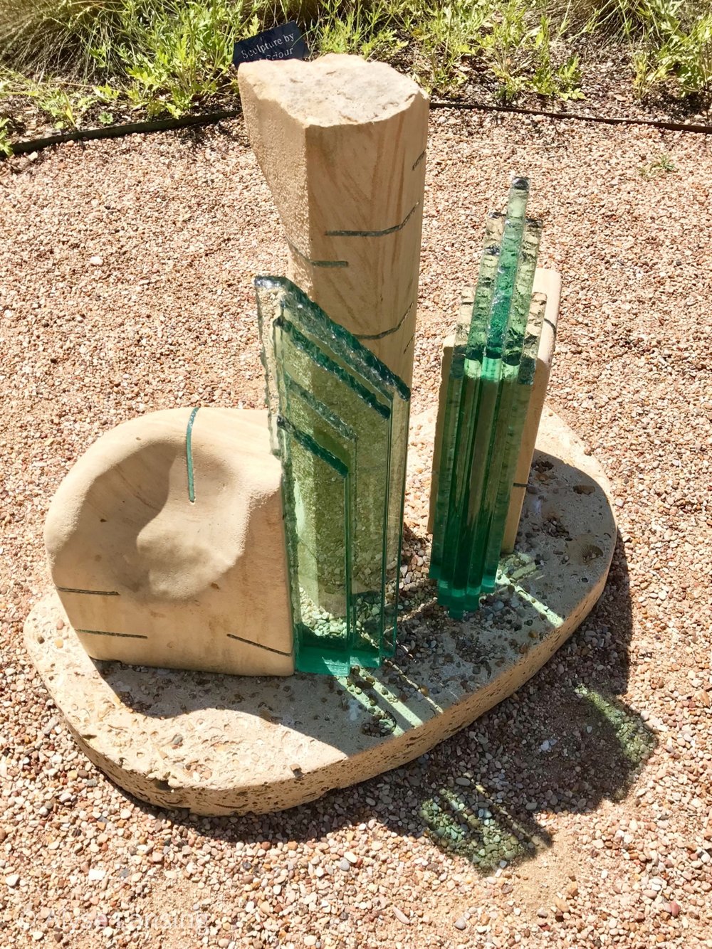  This glass sculpture, on the center axis through the courtyard, caught my eye. When the sun is angled lower in the sky, it would make an even bigger shadow on the surface below. It looked like water. 