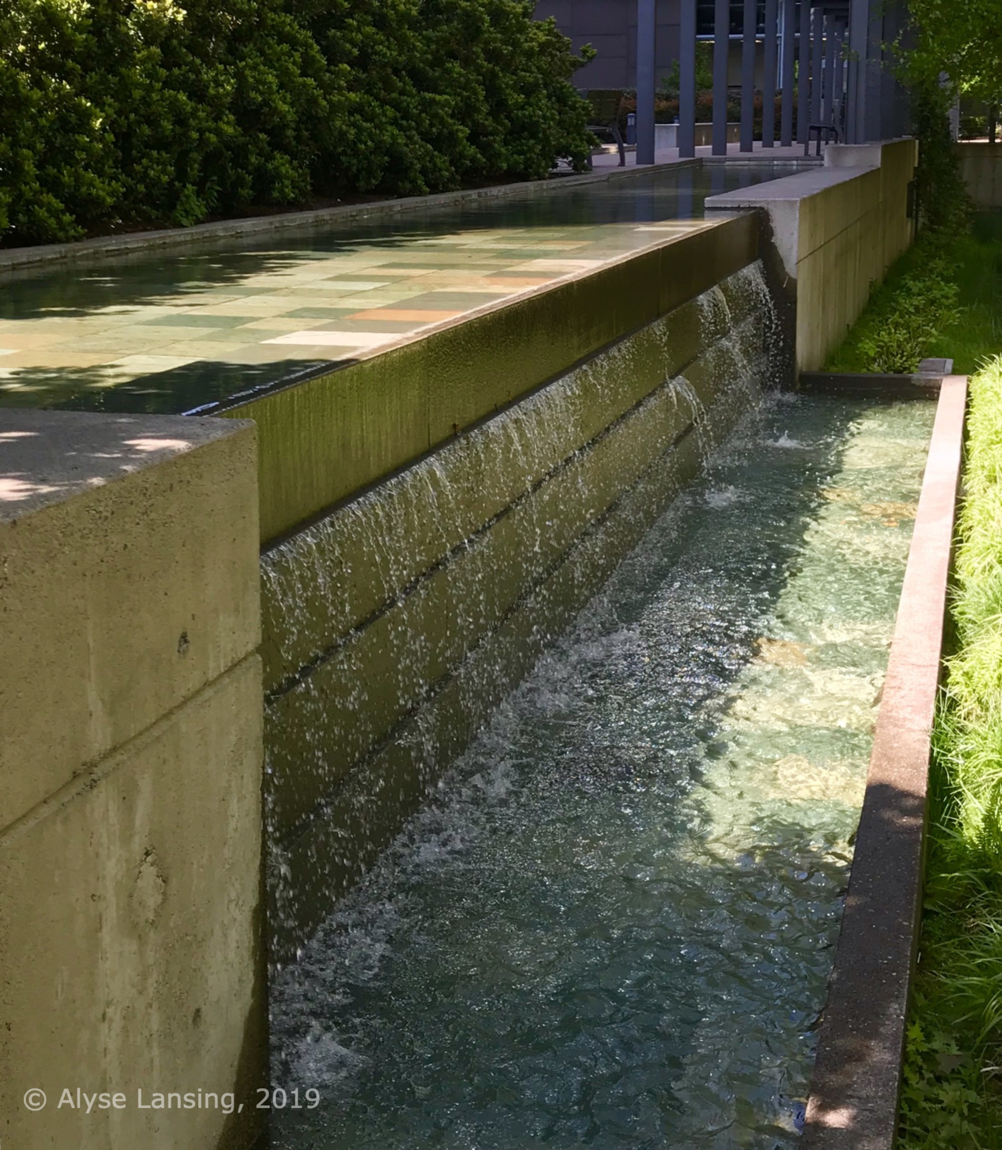 Handsome waterfalls outside the Atwater building, on the public walkway Pennoyer Street.