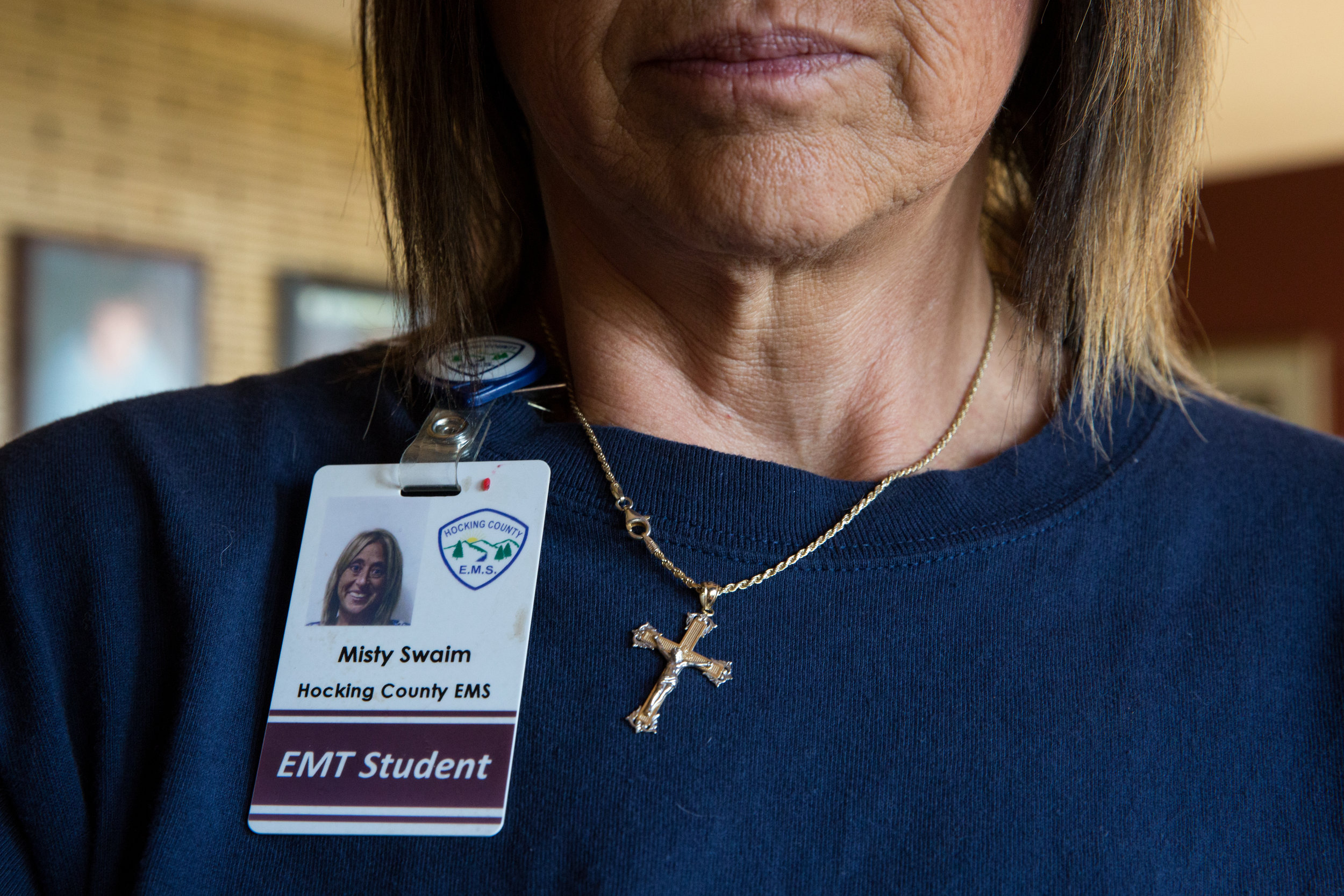  Misty wears her badge and crucifix necklace with her uniform. Misty's main goal is to help people, especially addicts and the homeless. 