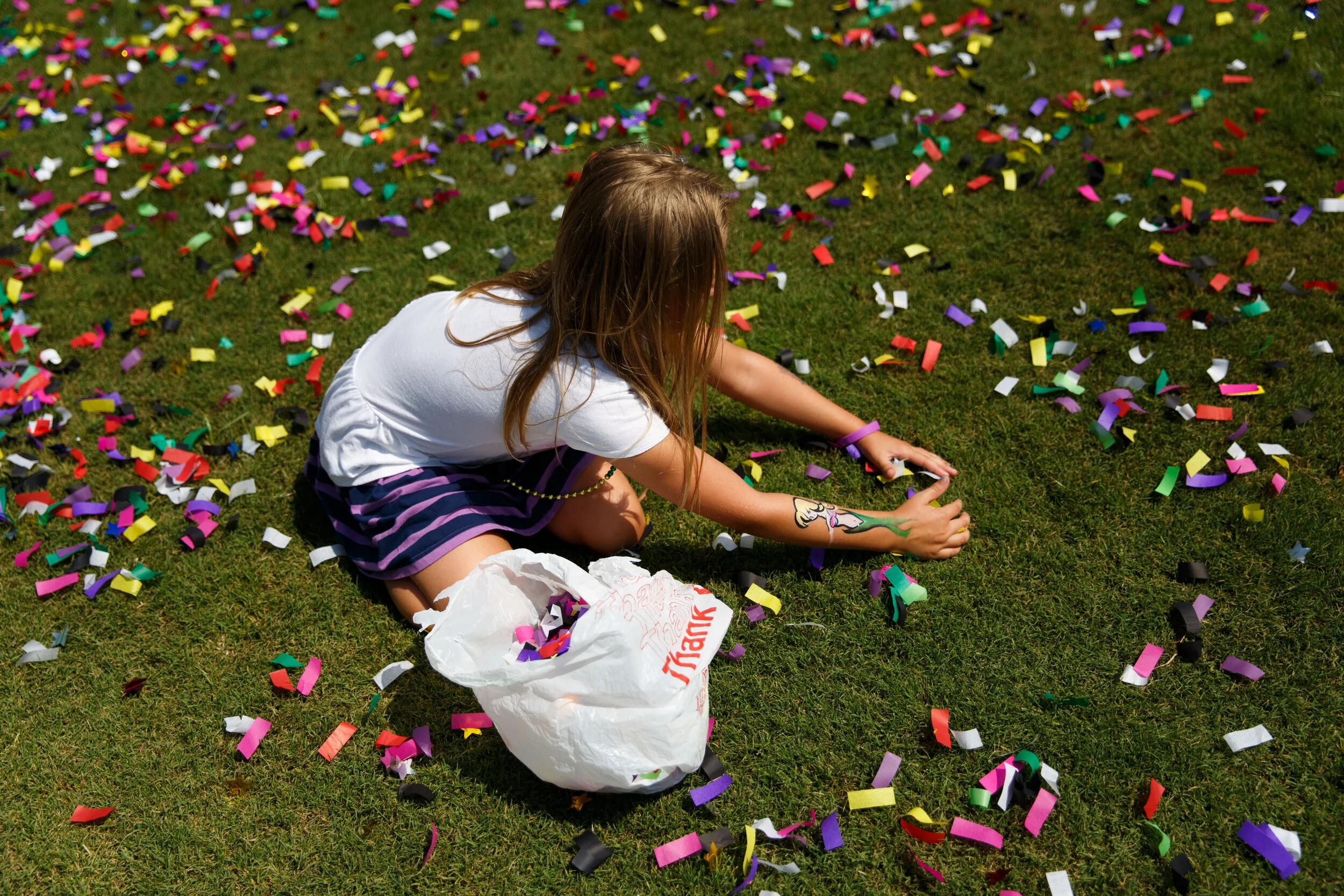 Serenity York, 9, collects confetti from the ground during Hampton Roads PrideFest at Town Point Park in Norfolk, Virginia, on Saturday, June 30, 2018. York said she planned to dump the bag of confetti over her head when she got home. 