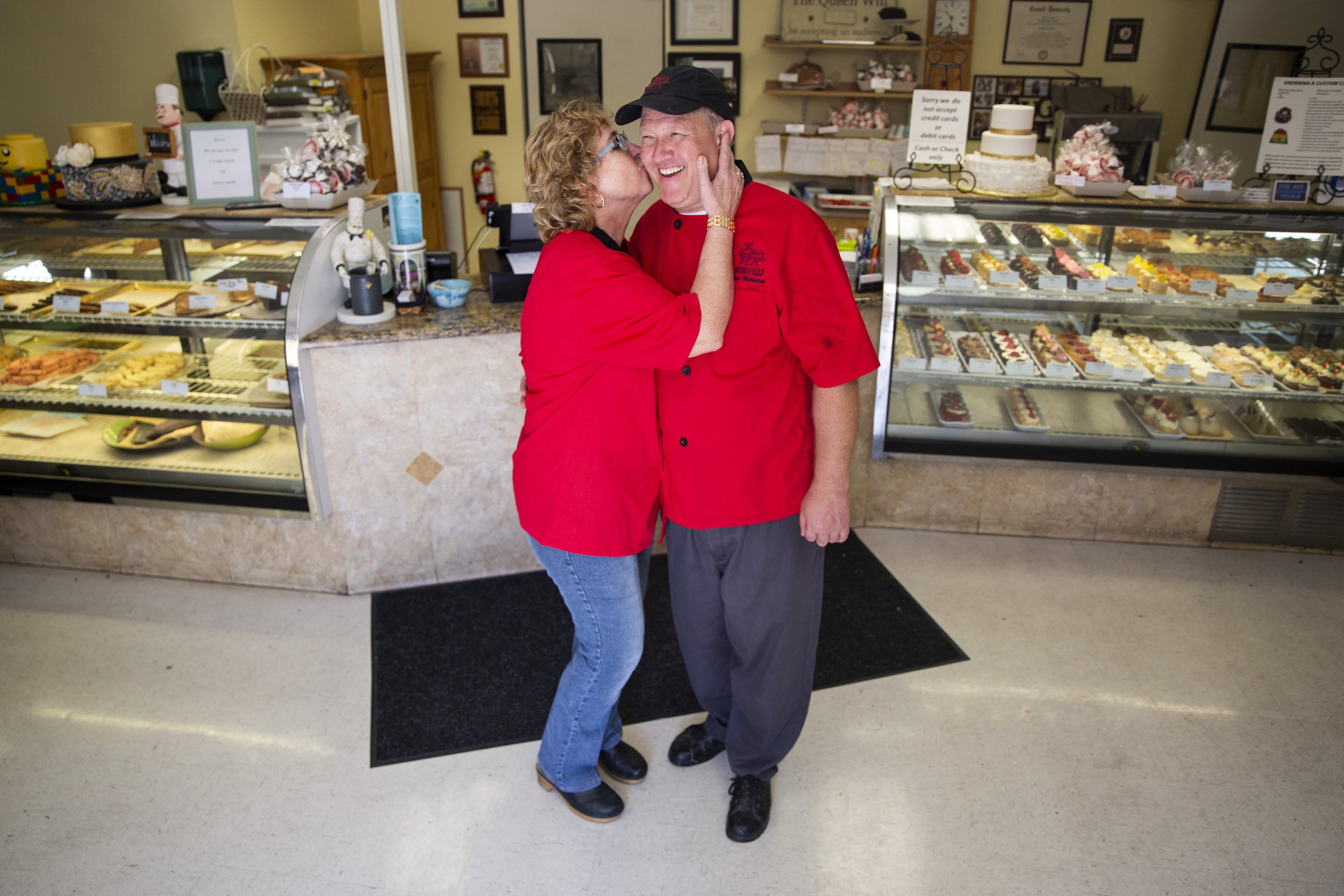  Elizabeth Mikkelsen kisses her husband and business partner Paw Mikkelsen on the cheek while at Mikkelsen's Pastry Shop in Naples, on Thursday, February 7, 2019. 