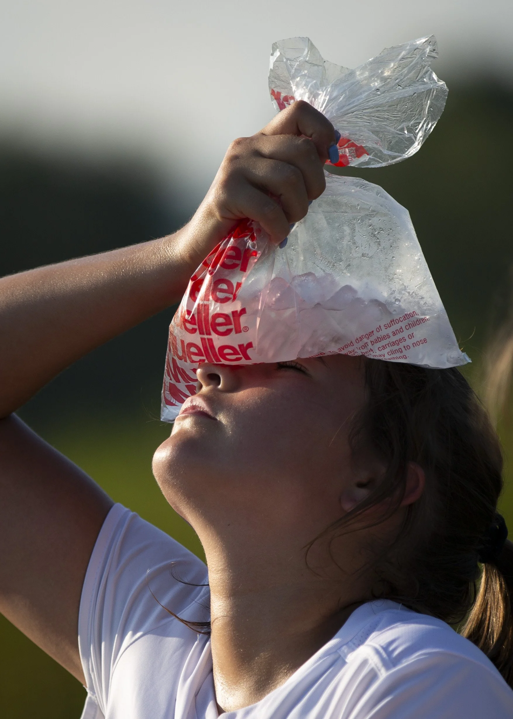  Mascoma defender Bella Davis (14) holds a bag of ice to her forehead to cool down at halftime during a girls varsity soccer game at Newport Middle High School in Newport, N.H., on Wednesday, Sept. 6, 2023. 