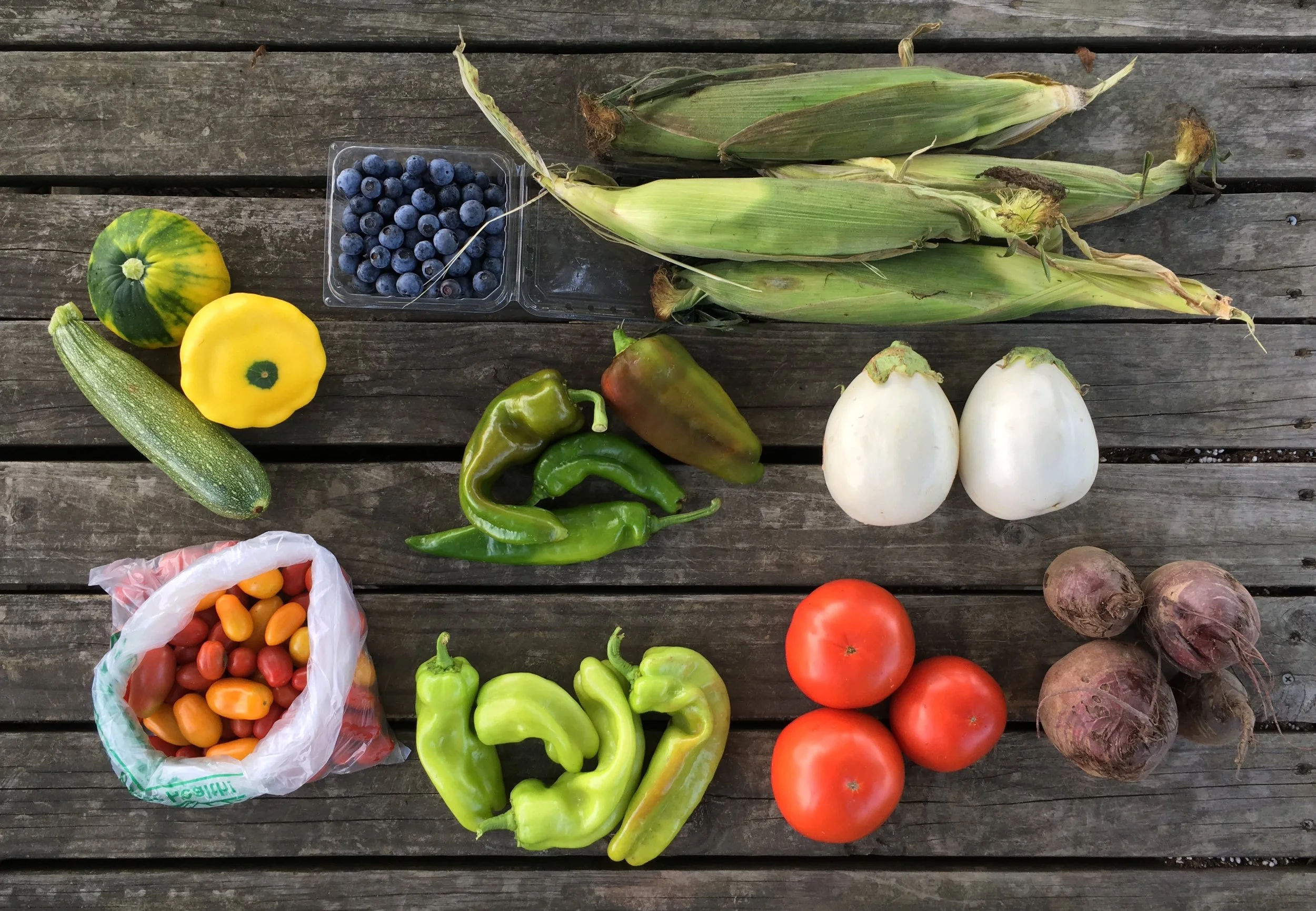 Top Row: Zucchini and Squash, Blueberries, Anaheim Peppers, Corn, and Eggplant Bottom Row: Cherry Tomatoes, Cubanelle Peppers, Beefsteak Tomatoes, and Beets
