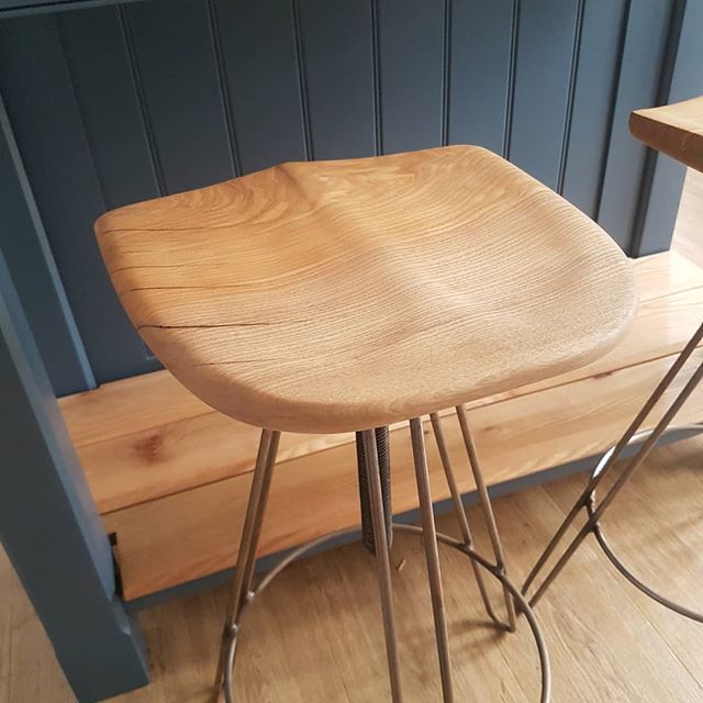 Kitchen stools that were made earlier this week. Each seat is made from a single piece of English ash, and carved and shaped by hand to get to the final shape. The cracks and checks in the timber are kept, but are filled with black tinted epoxy befor