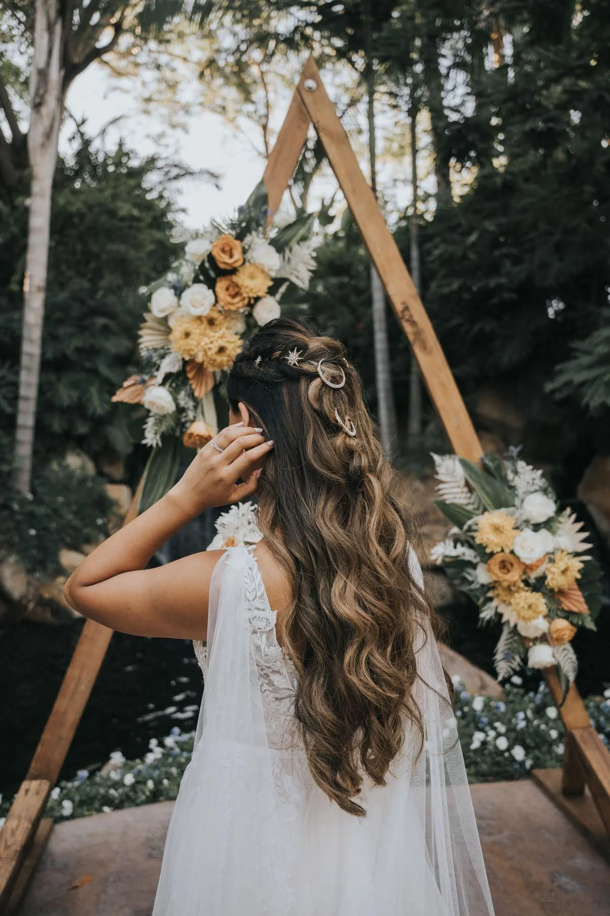 Back view of a bride with long flowing waves styled for her wedding day.