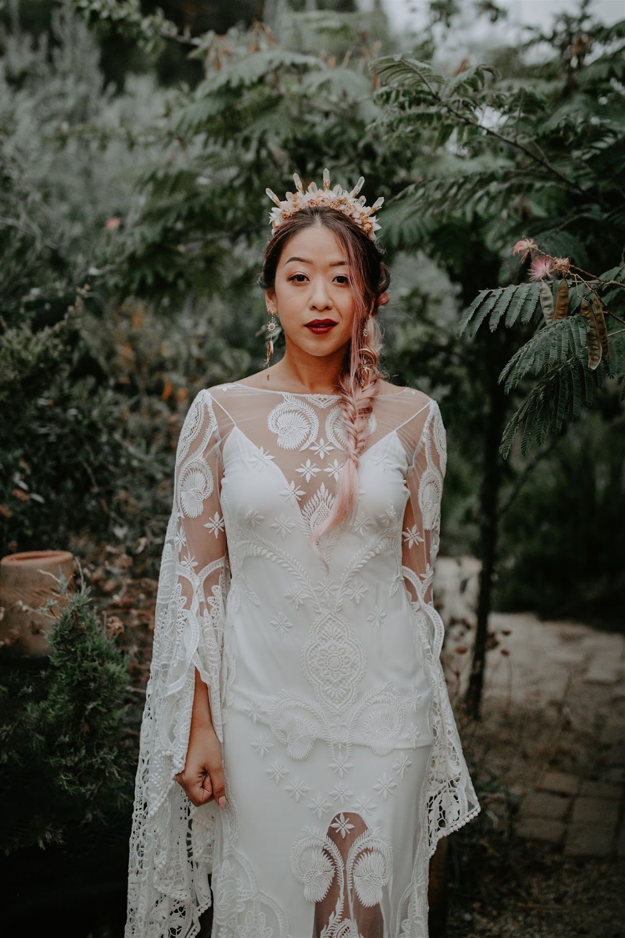 Bride in a lace wedding dress standing outdoors for a Just Lago client love note.