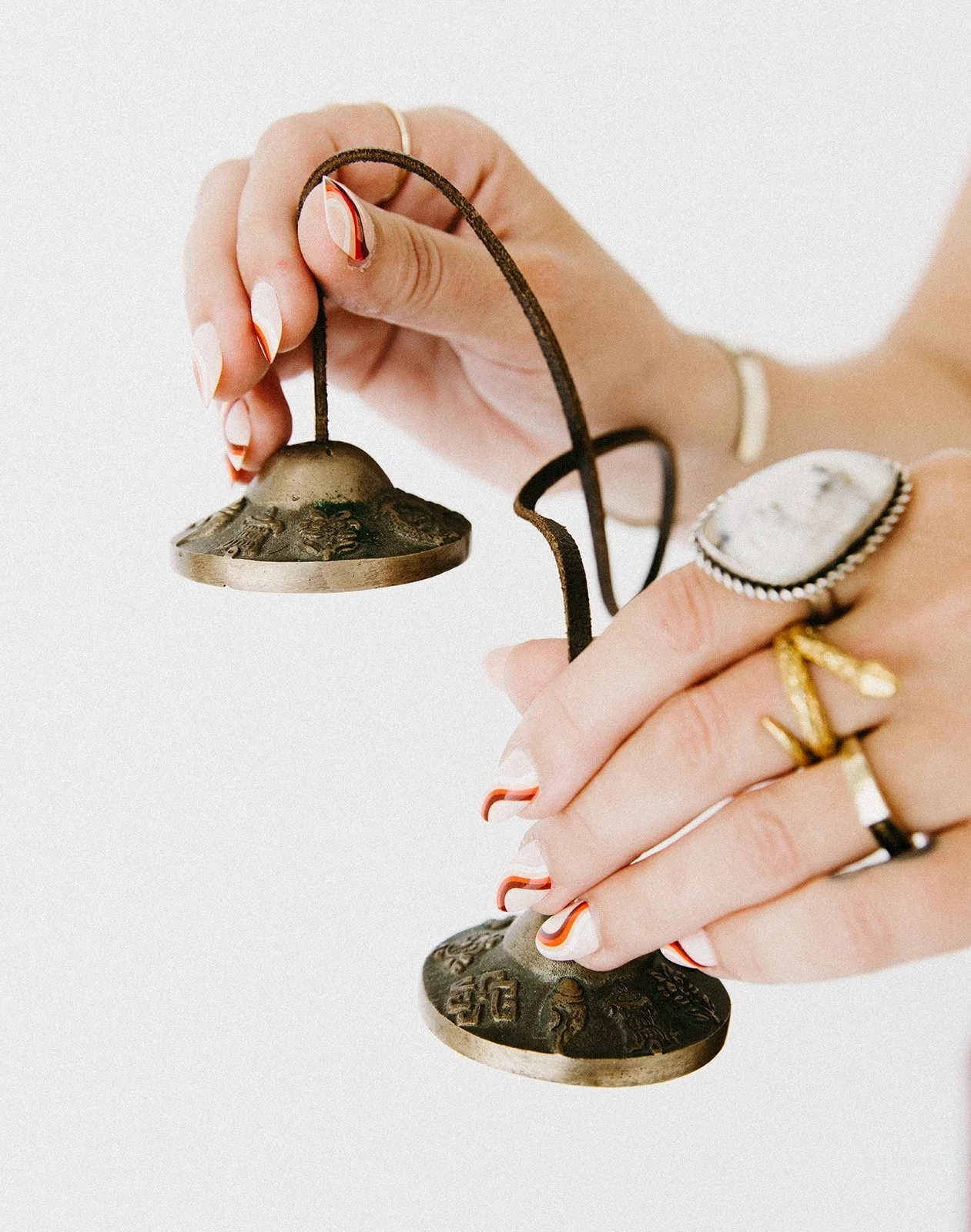 Hands holding meditation cymbals used during a corporate wellness sound session.