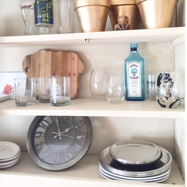 Our built-in kitchen hutch has to be one of my favorite features in our home! This hutch is the perfect way to display our dishes, glassware, and accessories in a fun way! Our stainless steel plates, stemless wine glasses, and appetizer plates are from cb2. Buffalo accessories are from the Visit Buffalo Niagara Visitor Center in the Brisbane Building downtown Buffalo, and the handpainted wine glass is from Betsy Lynn Designs based out of Rochester, NY. 