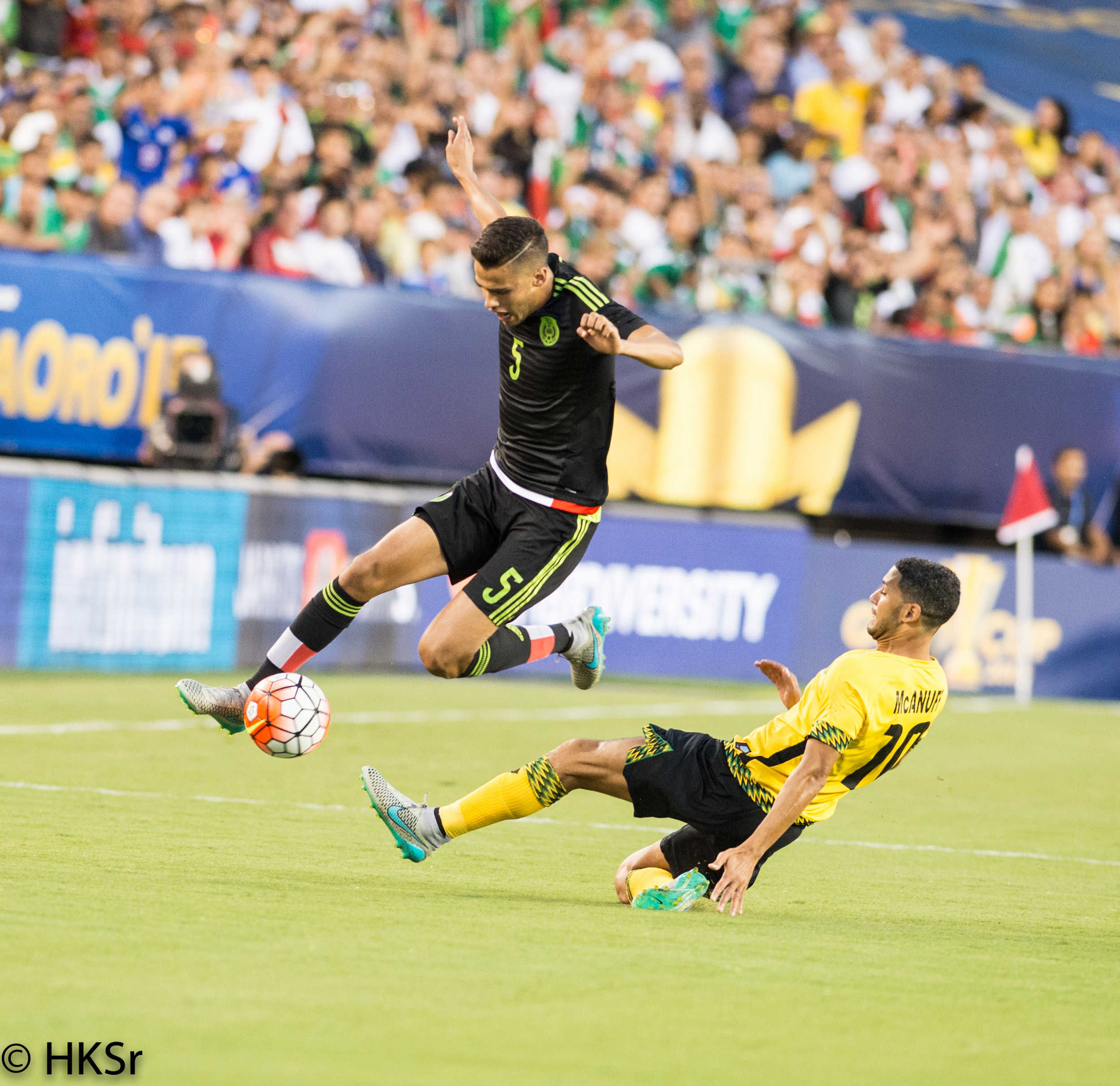 Jamaica #10 Joel McAnuff slides under Mexico #5 Diego Reyes