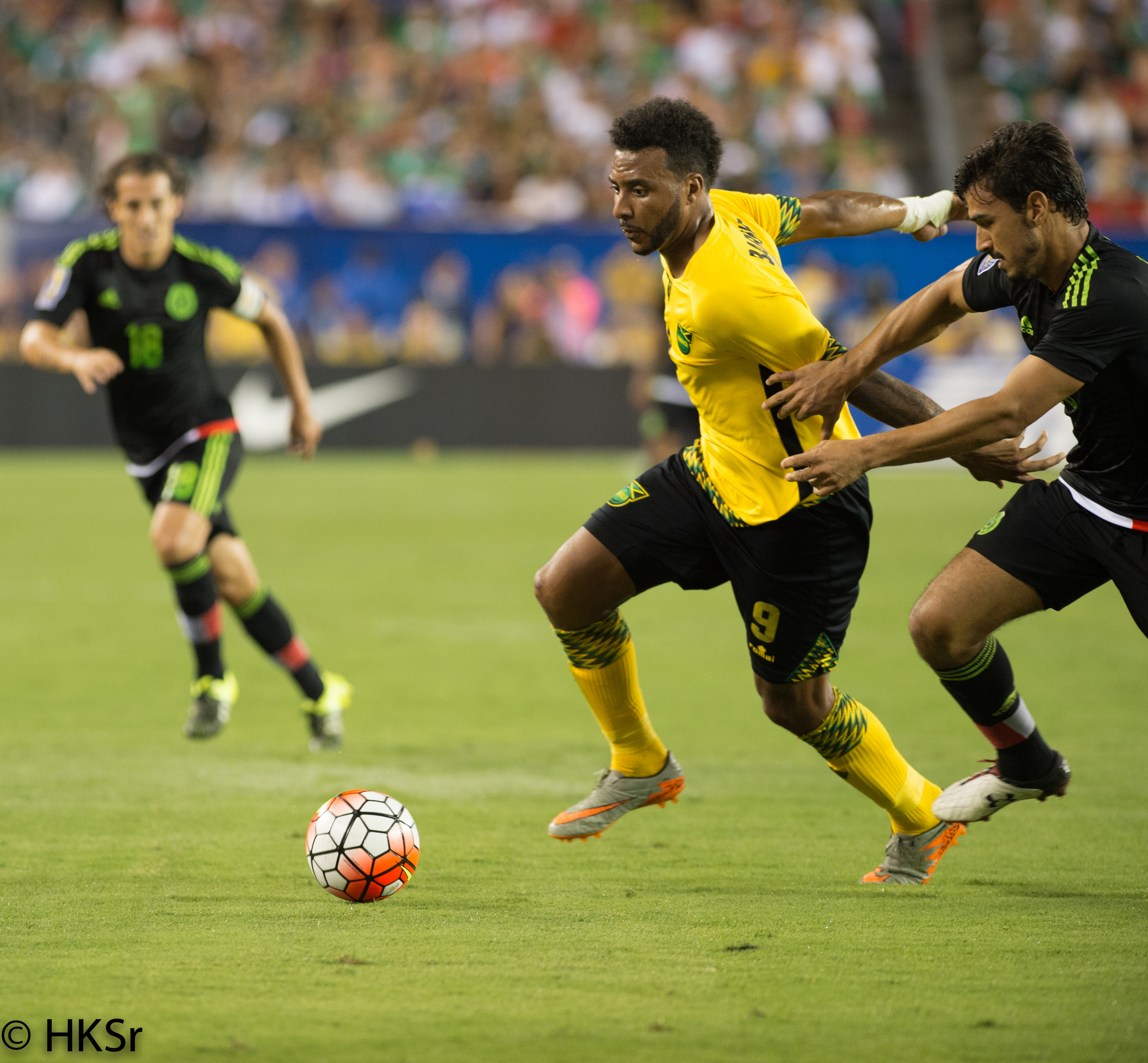 Jamaica #9 Giles Barnes holds off defender