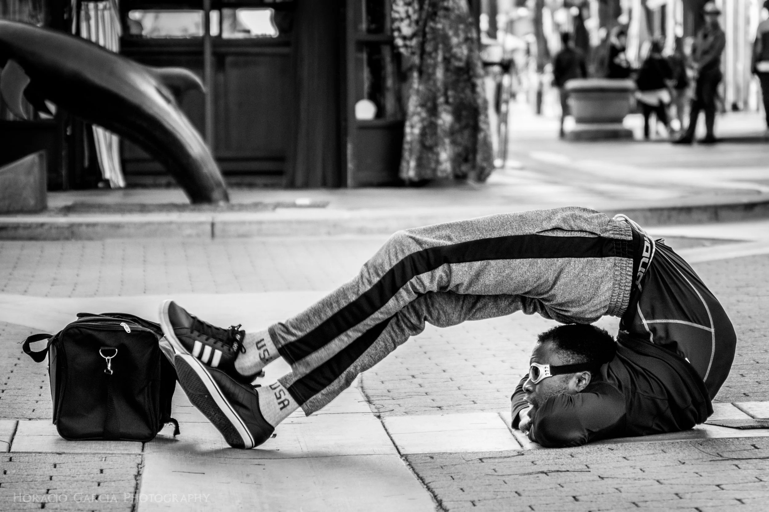 Contortionist Soumaa puts on a visually astounding performance for people at the 3rd Street Promenade in Santa Ana, CA