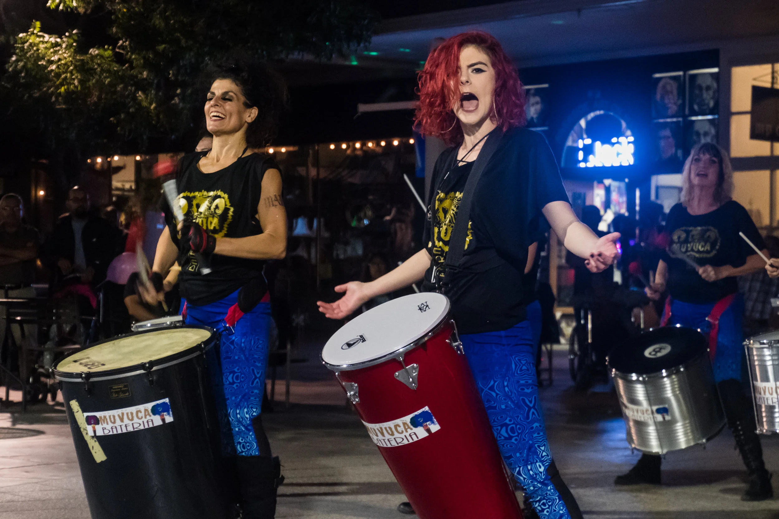 "COME ON!" Muvuca Bateria Founder Julie Simon (left) and Hannah Wolgemuth (right) enthusiastically acknowlegde the crowd during an impromptu performance during Long Night of Arts and Innovation in Downtown Riverside. Muvuca Bateria is an All female Brazilian Inspired Drum Group.