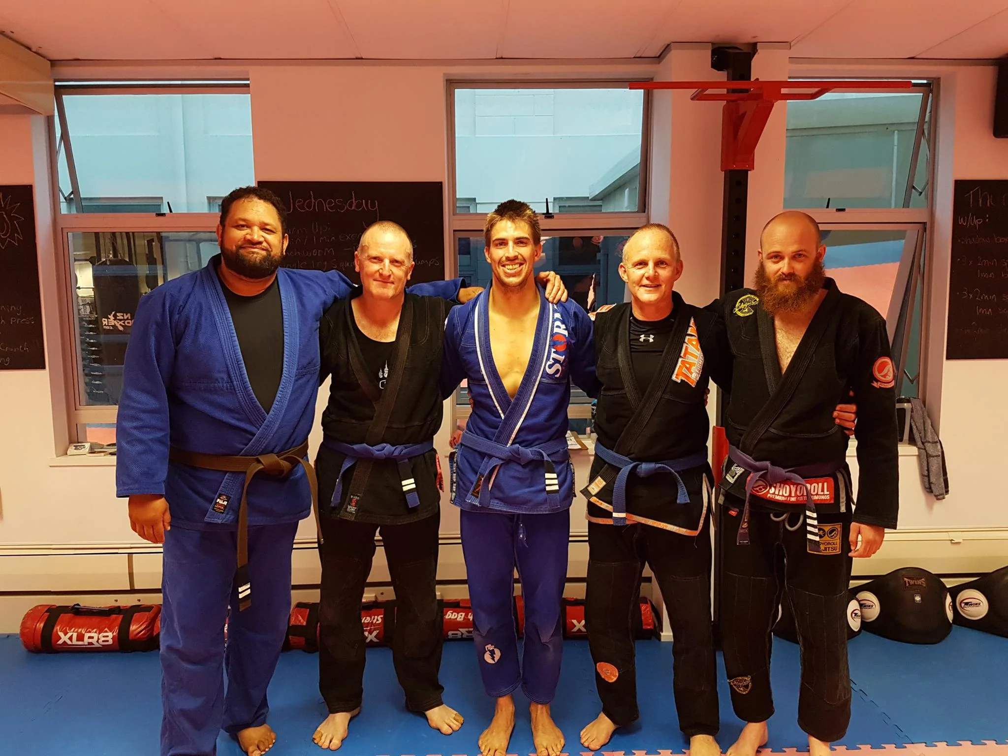 From left to right: Coach Jay, blue belts Danny, James, and Jimmy who all achieved new tabs, and Coach Andrew.