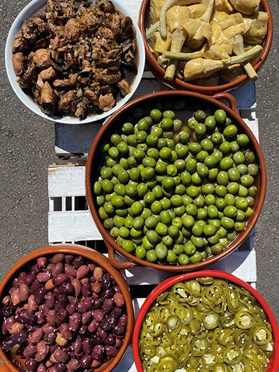 Antipasto platter with olives, artichokes and marinated mushrooms.