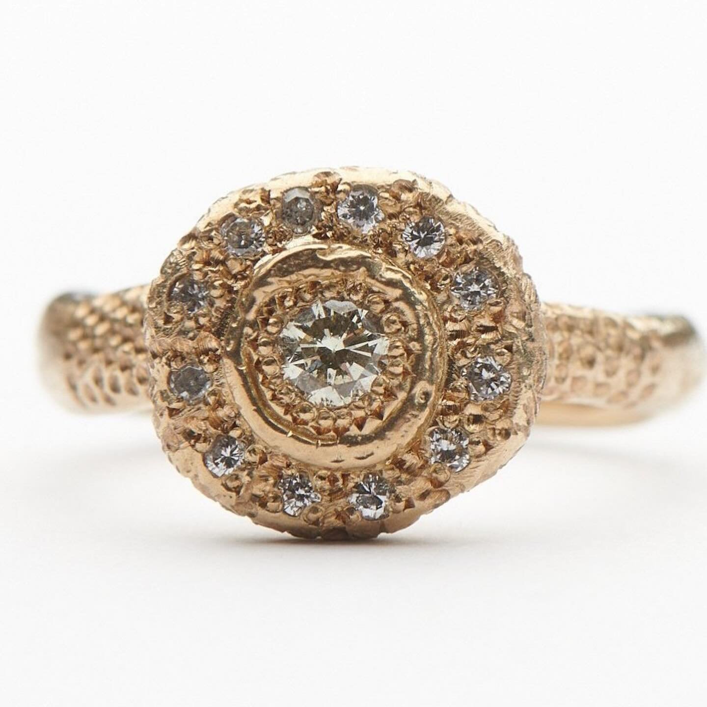 Enchanting diamonds and hand engraved details. 

9ct yellow gold Circe ring set with a collection of diamonds. This ring has been hand engraved with both feather and dot motifs.

The Circe ring can be made to order in your choice of gold and gemstone