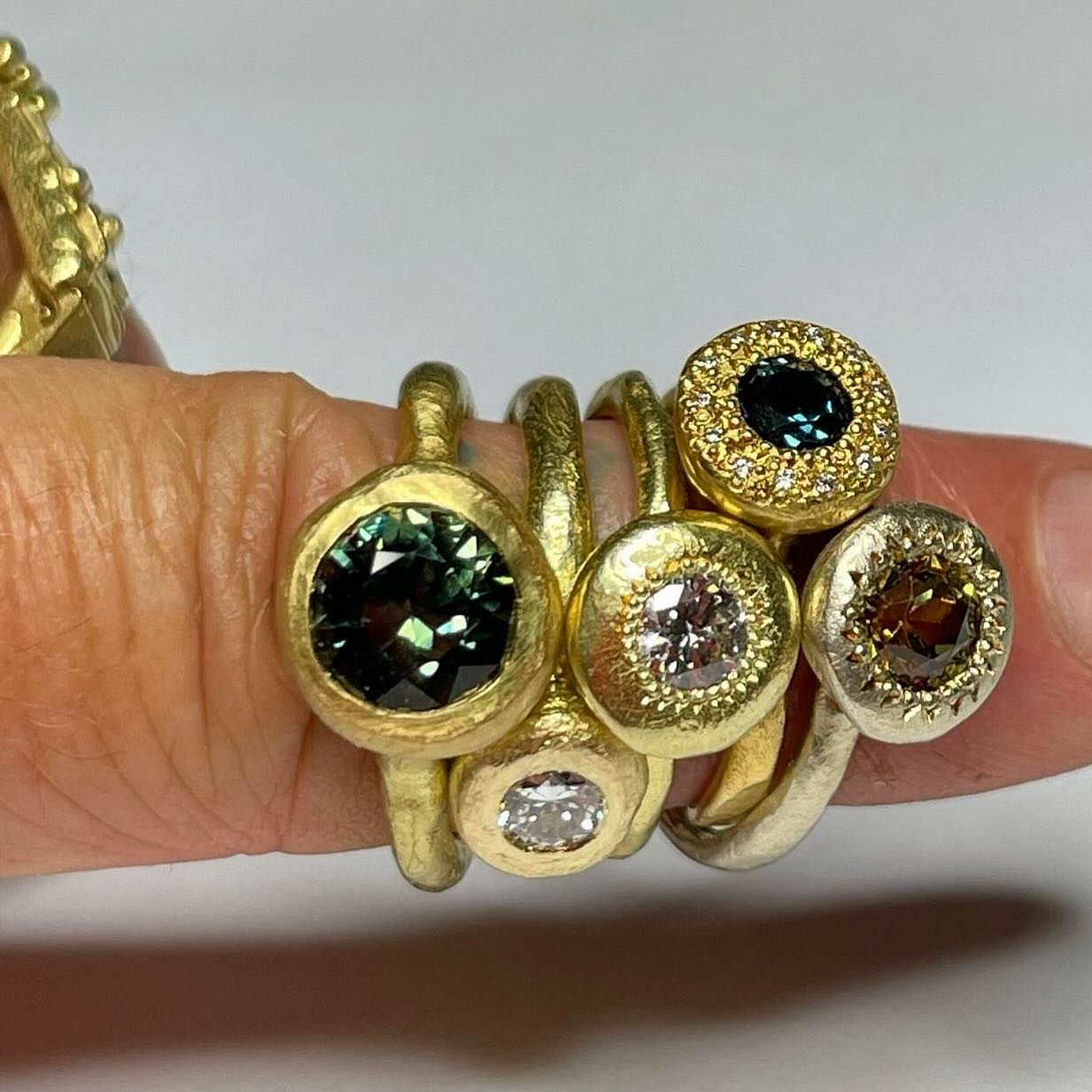 All the rings!

18ct yellow gold To Manifest set with an 8mm
Australian parti sapphire.
18ct yellow gold To Hold ring set with an old cut diamond.
18ct yellow gold Large Pledge ring set with a diamond.
18ct yellow gold Large Pledge ring set with an A