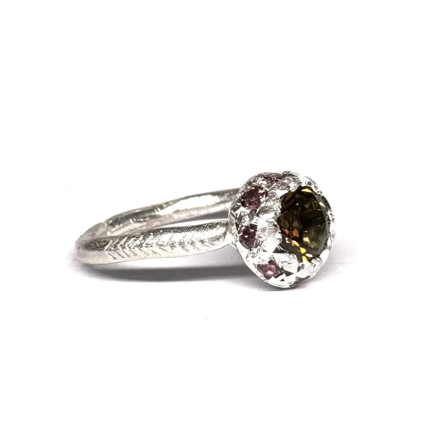 A beautiful combination of natural gemstones.
#117.
Series of One.
Hand engraved sterling silver, set with a central brown tourmaline and surrounded by natural coloured sapphires.

Available at the studio (open by appointment) and on the online store