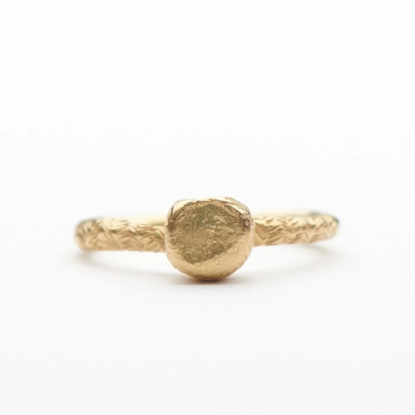 Encens is a French word that translates as &ldquo;incense&rdquo;.
The top round shape is based on a charcoal disc used for burning resin incense.

18ct yellow gold Encens ring with hand engraving.

The Encens ring is available to purchase through my 