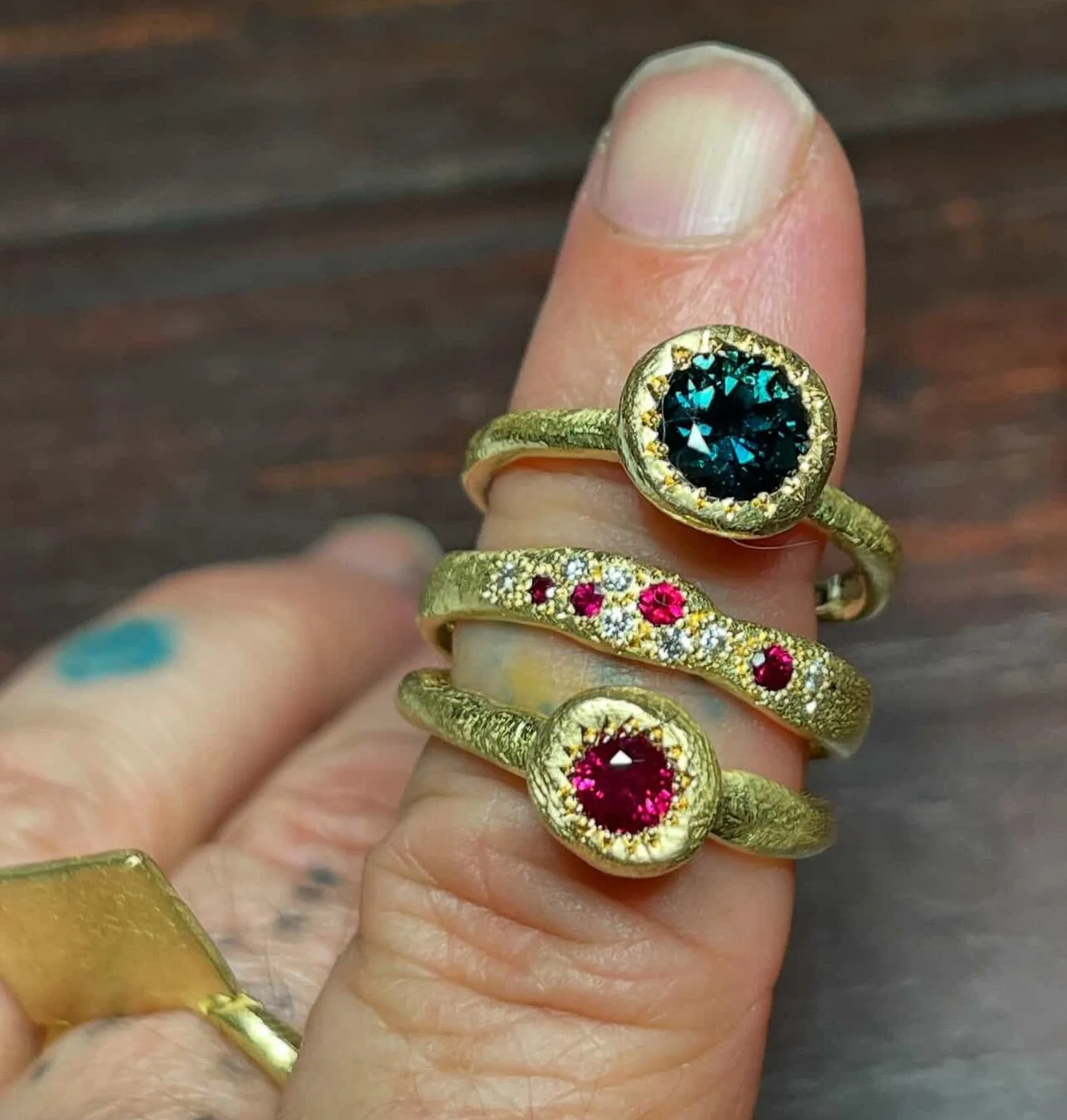 Three rings.
(From the top)

The Large Pledge ring can hold up to a 7mm round gemstone. As a pledge is a solemn promise or undertaking. This ring design sits higher, the shank is thinner to accentuate the one gemstone held high. There is a 9ct yellow