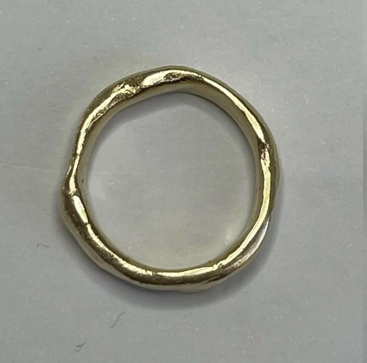 9ct yellow gold Wonkier Wonky wedder.
18ct yellow gold Wonky wedder.

Both rings have varying wall and widths. The Wonkier Wonky wedder is wider and heavier than the Wonky wedder. It is also wonkier.
Many years ago when I was a student, a lecturer th