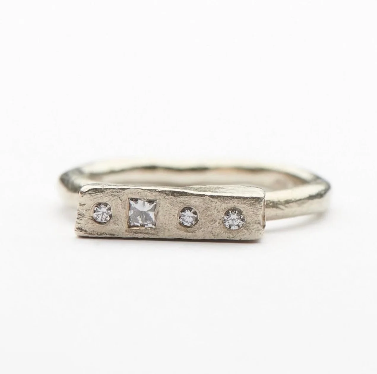 9ct white gold Mneme ring set with white diamonds.

In mythology, Mneme was the muse of memory. Also known as Mnemosyne. According to Hesiod, the Ancient Greek poet, Mnemosyne was the mother of the Nine Muses.

In &lsquo;Orlando&rsquo;, Virginia Wool