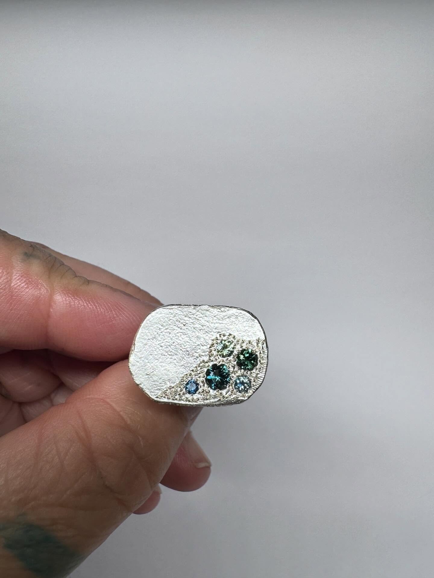A ring for Alex.

Sterling silver Signet ring set with a selection of natural Australian parti sapphires.

I have been making variations of this ring for almost 20 years. I like setting the gemstones in a corner, so it looks like they naturally forme