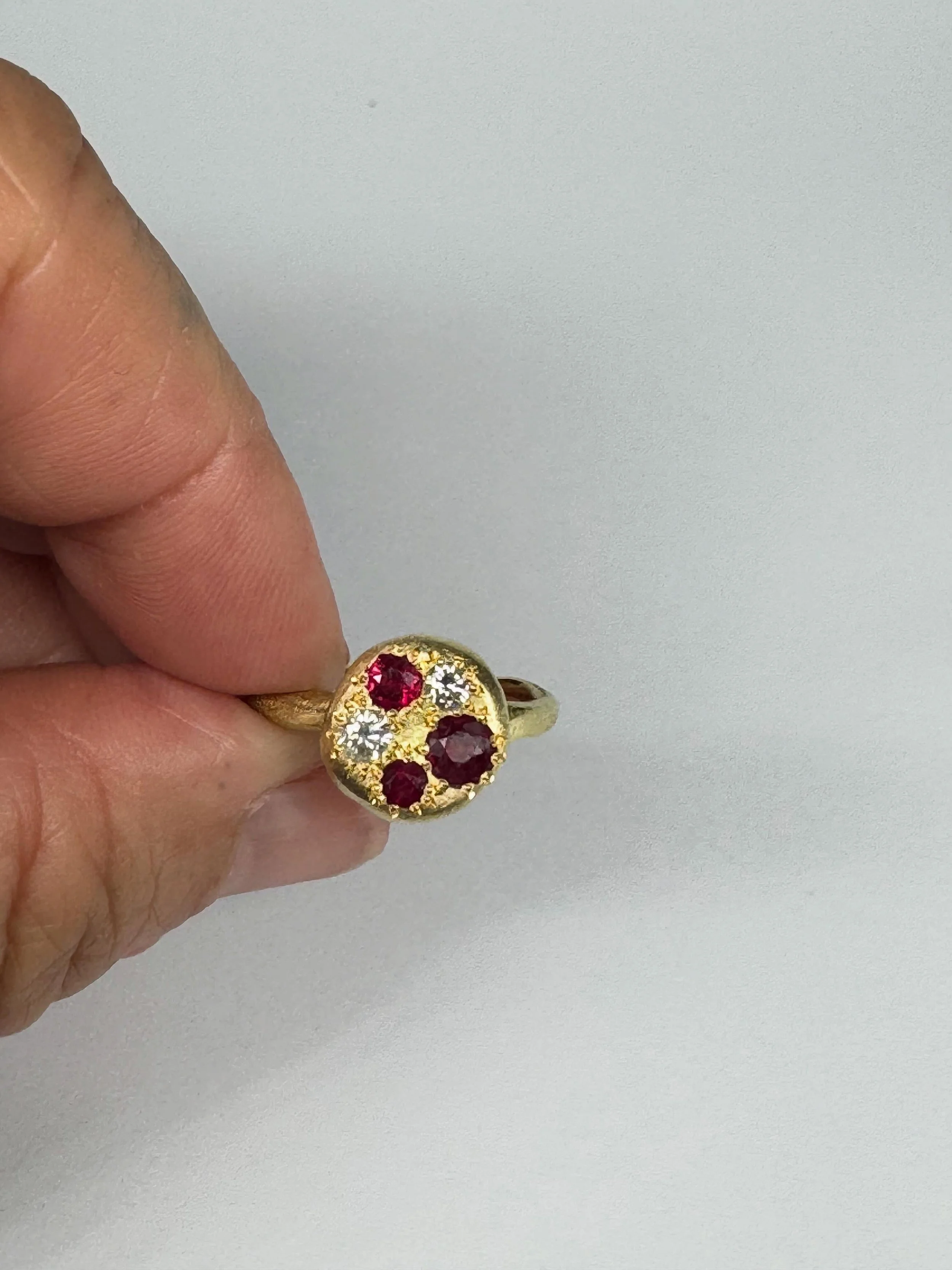 A ring for Anne.

18ct yellow gold set with rubies and diamonds.

This ring was commissioned using Anne&rsquo;s beloved mother&rsquo;s ring.
When we discussed the design of this ring we felt that all the gemstones should be clustered together, held f
