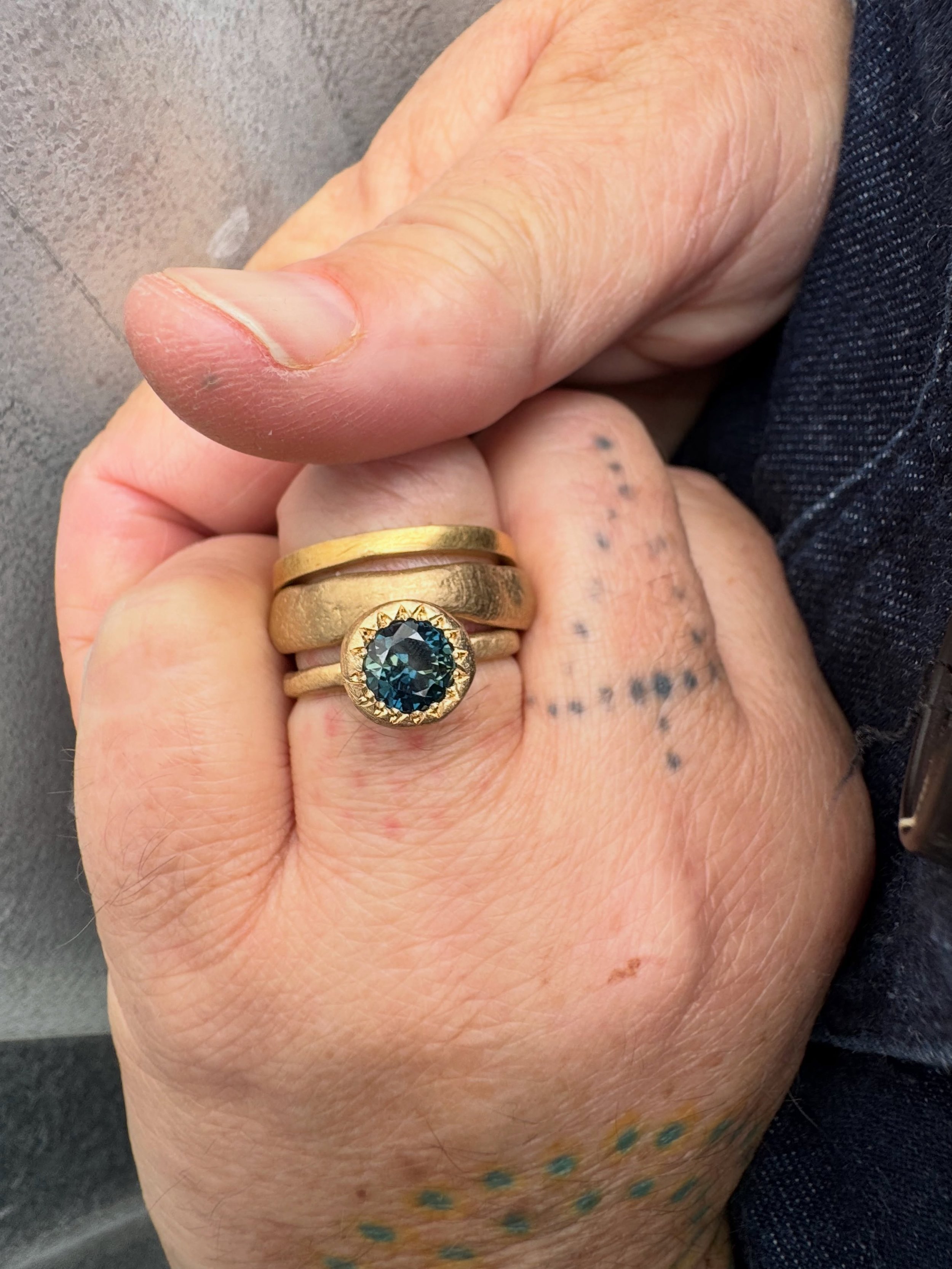 Ring Stack.

9ct yellow gold Uni&oacute;n Ring
9ct yellow gold Wonkier Wonky Wedder
9ct yellow gold Large Pledge Ring set with natural Australian parti sapphire - the most beautiful blue, just like the sea! 

These rings are available to view at the 