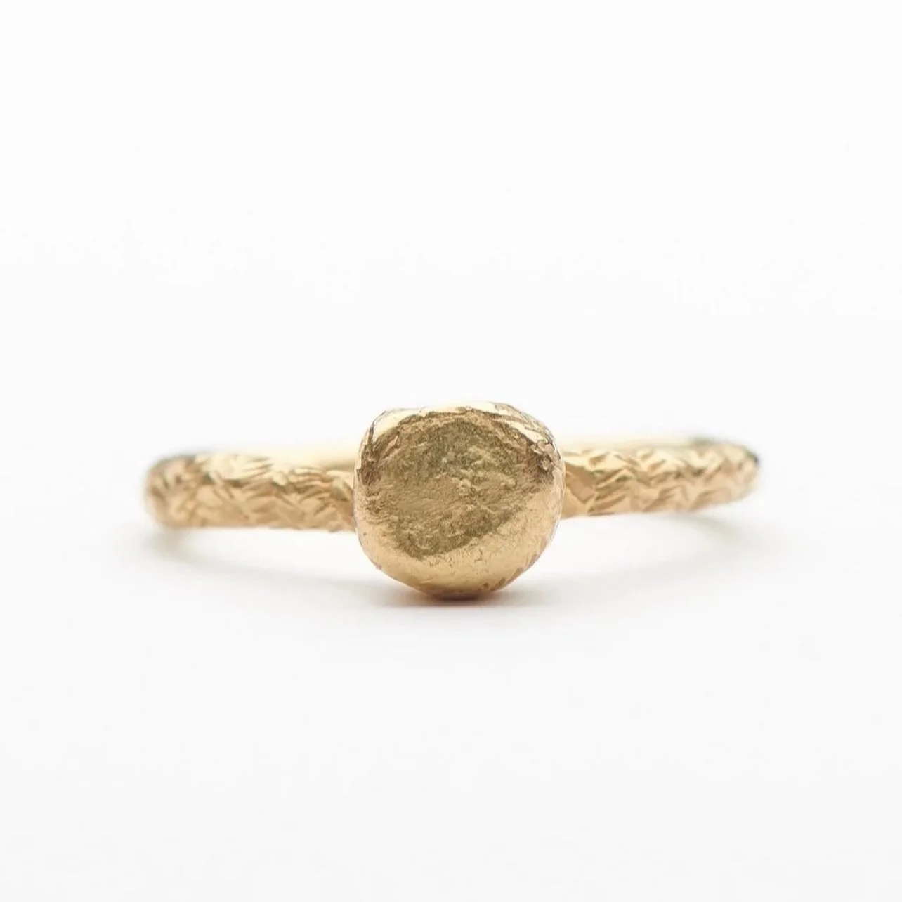 Encens is a French word that translates as &ldquo;incense&rdquo;.
The top round shape is based on a charcoal disc used for burning resin incense.

18ct yellow gold Encens ring with hand engraving.

The Encens ring is available to purchase through the