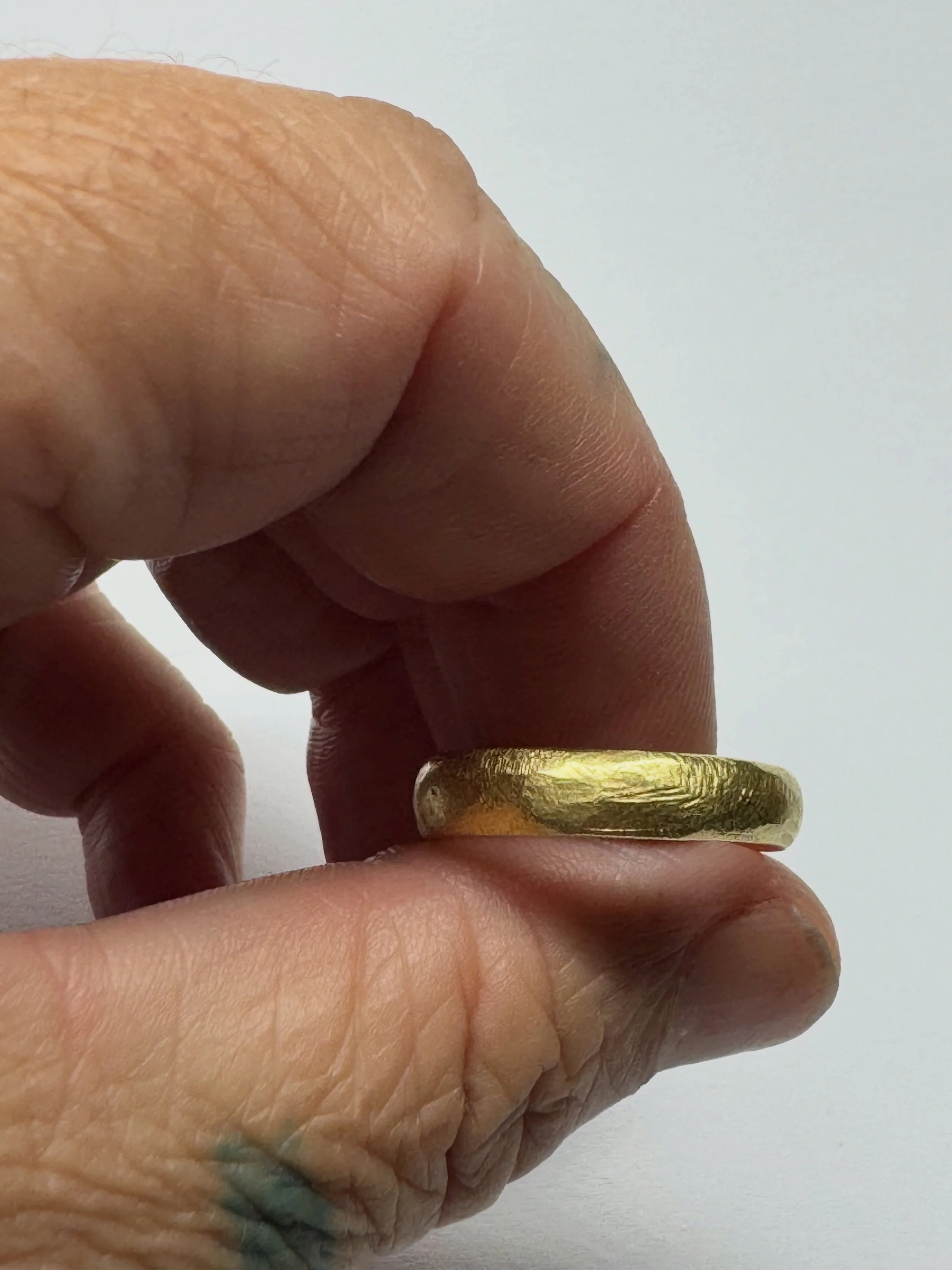 File Mark Wedder.
I have been making variations of this ring for more than 20 years. Each one is hand carved.
This ring is just under 5mm wide and has a comfort fit, so is very easy to wear. A strong robust ring, made to be worn every day.

Over time