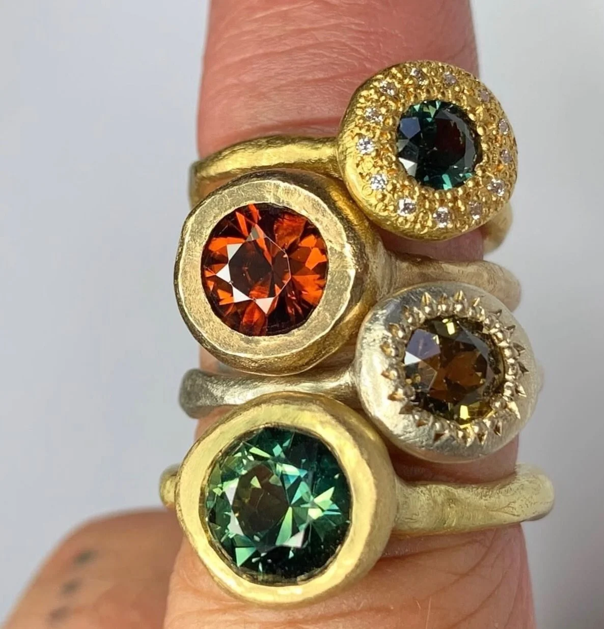 Four Rings.

Each holding unique gemstones,  each chosen for its unique beauty. The setting and design kept very simple to hold the treasure that is each gemstone. 

These designs can be made to order in your choice of metal and gemstone.

Email info