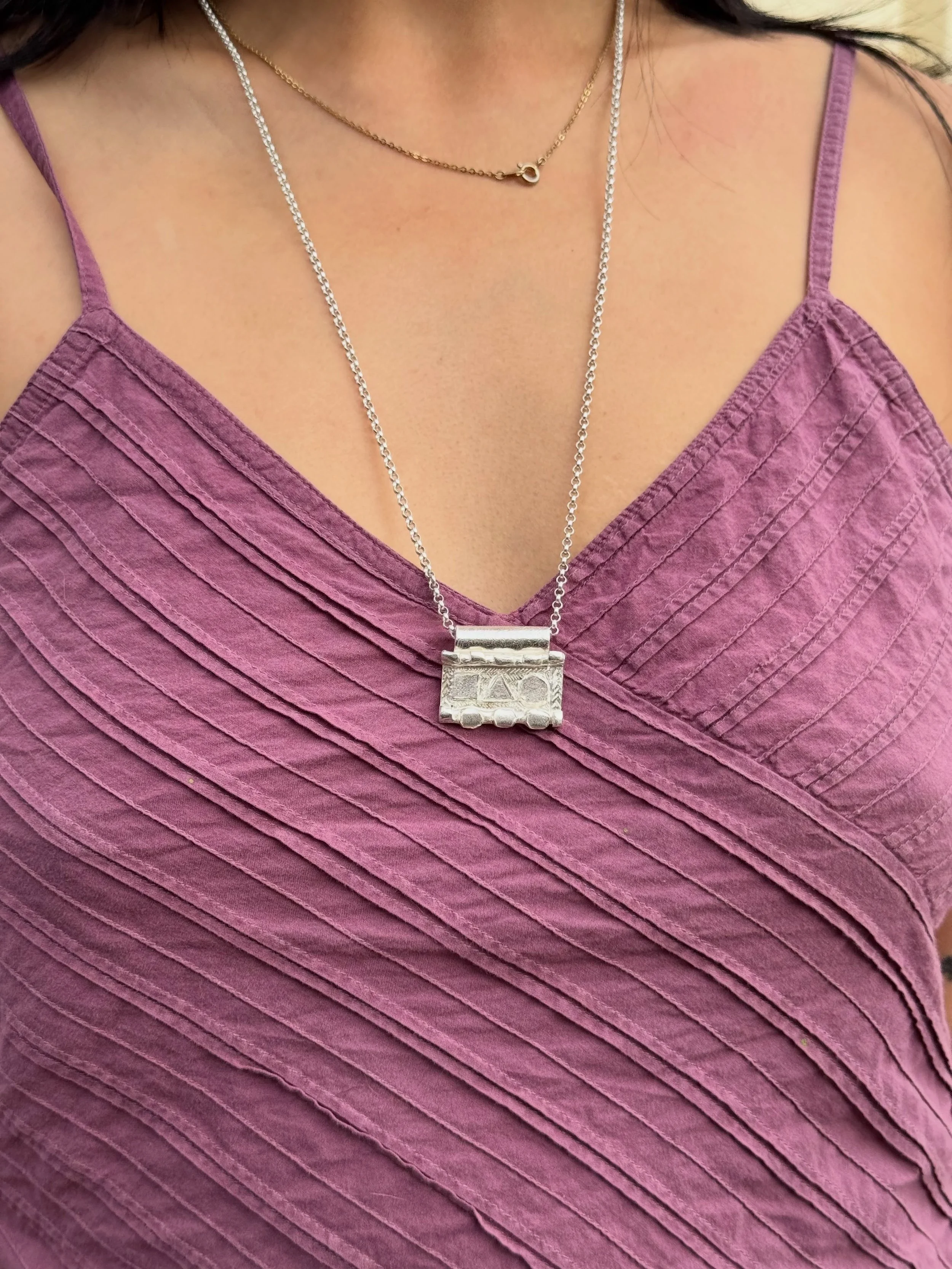 #140 - Handmade sterling silver pendant with hand engraving.
Worn here by @magggieluu 

Measurements: c. 29 x 23.5mm, thickness of pendant c. 2.5 - 7mm

Chain Lenth: 70cm
Weight: 22 grams

This piece is a one-off and not intended to be reproduced. Th