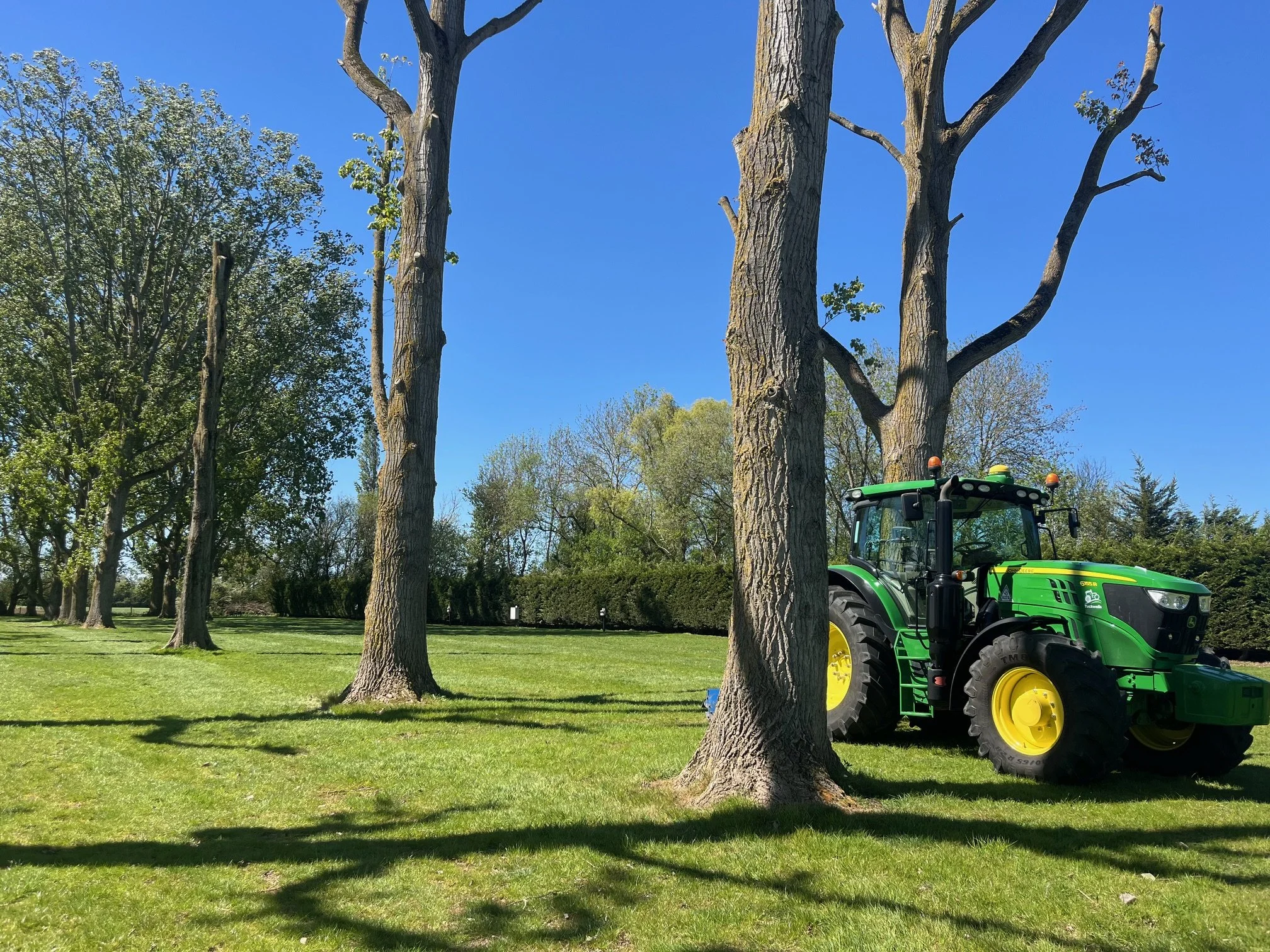 Green John Deere tractor working in camping field