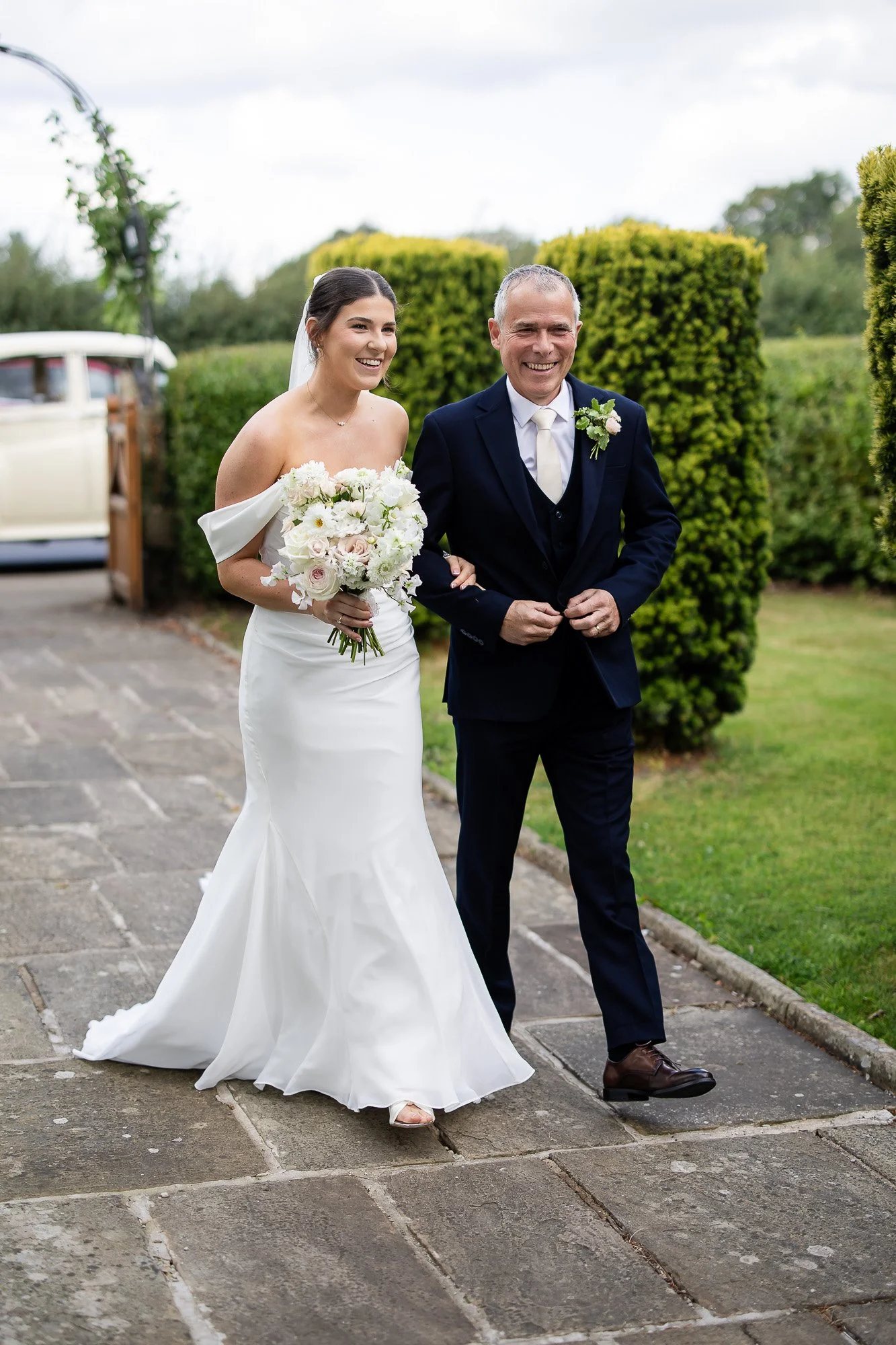 bride and dad walking into church