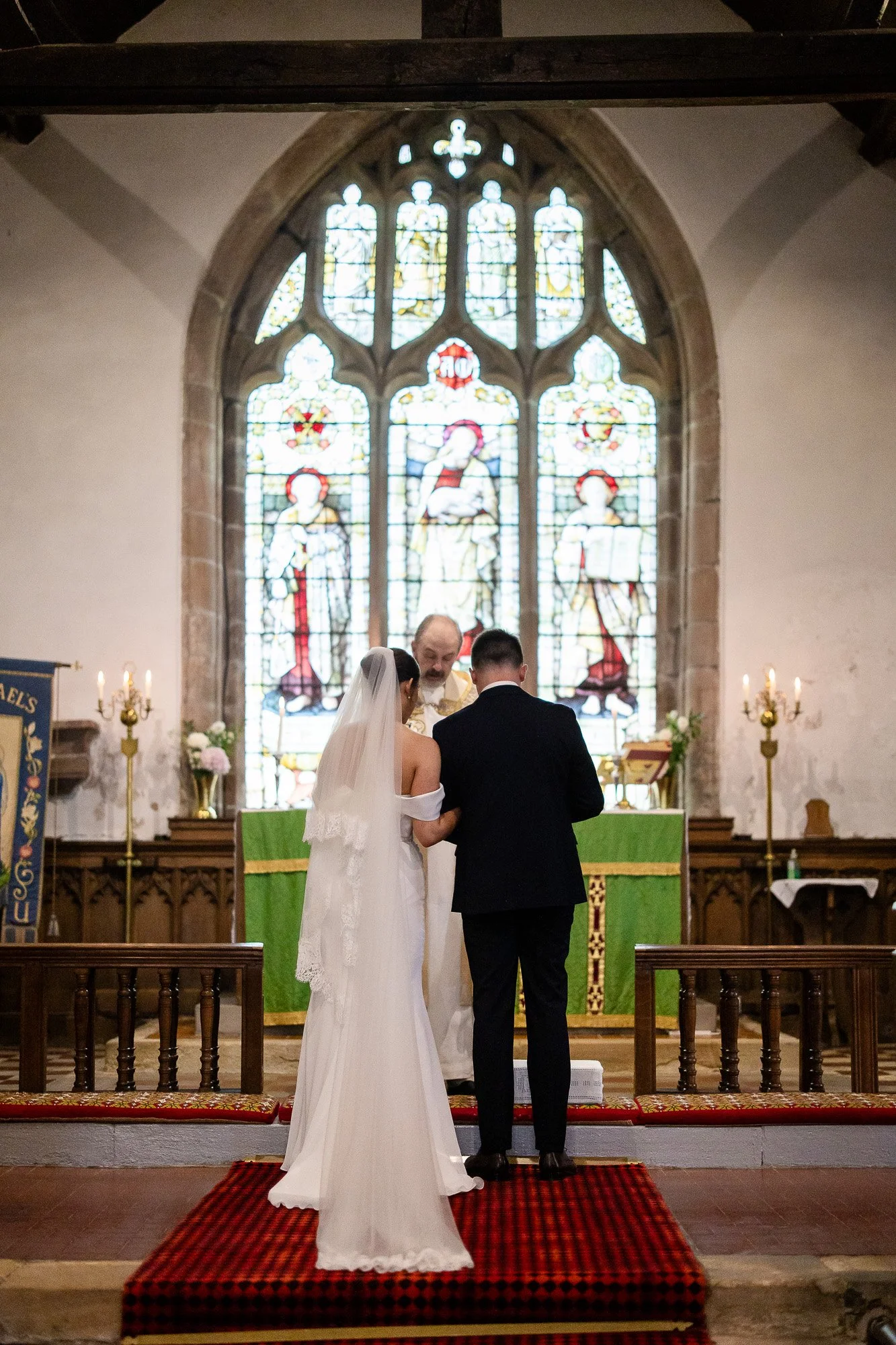 bride and groom at alter