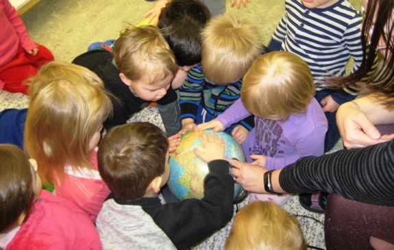 Kids in one of the Finnish kindergartens participating in the scrapbook campaign, curiously searching their scrapbook route on the map and learning about the world
