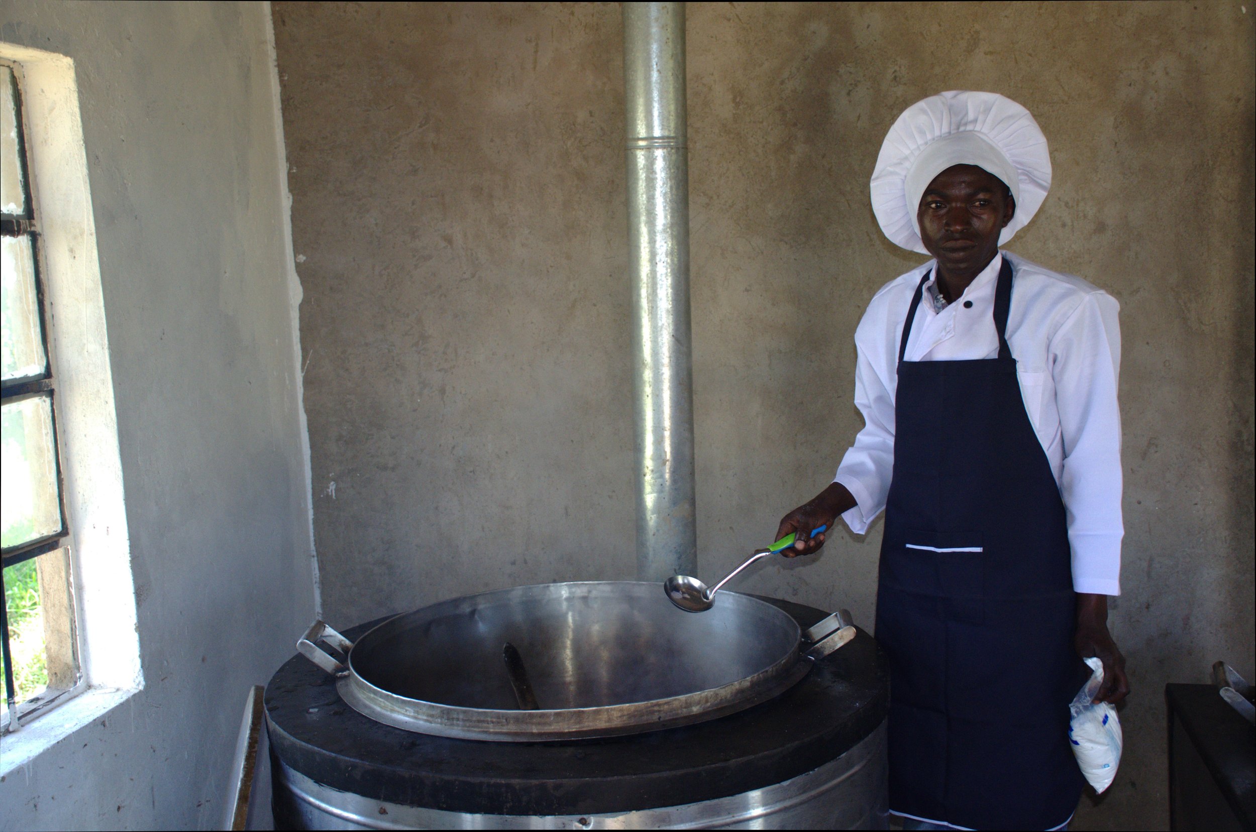 The chef at St. Mary's Girls Primary School in Machakos preparing a meal using an improved energy saving jiko. © David Wandabi