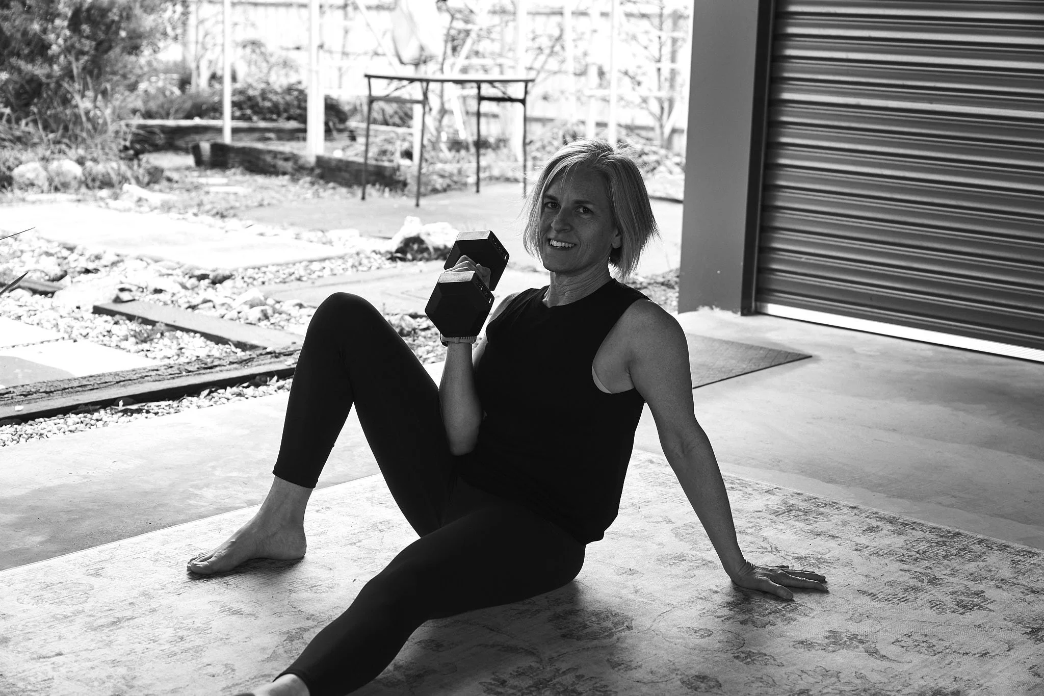 a woman in workout clothes following a strength training program for women at home