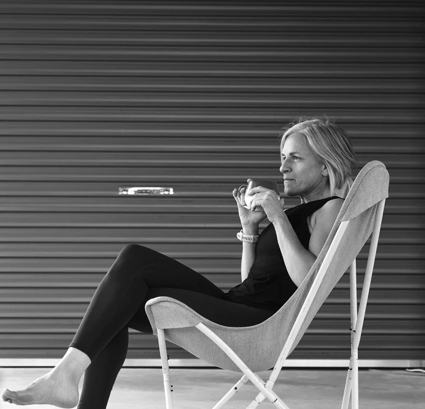 a woman over 40 drinking coffee before her strength and cardio workout at home
