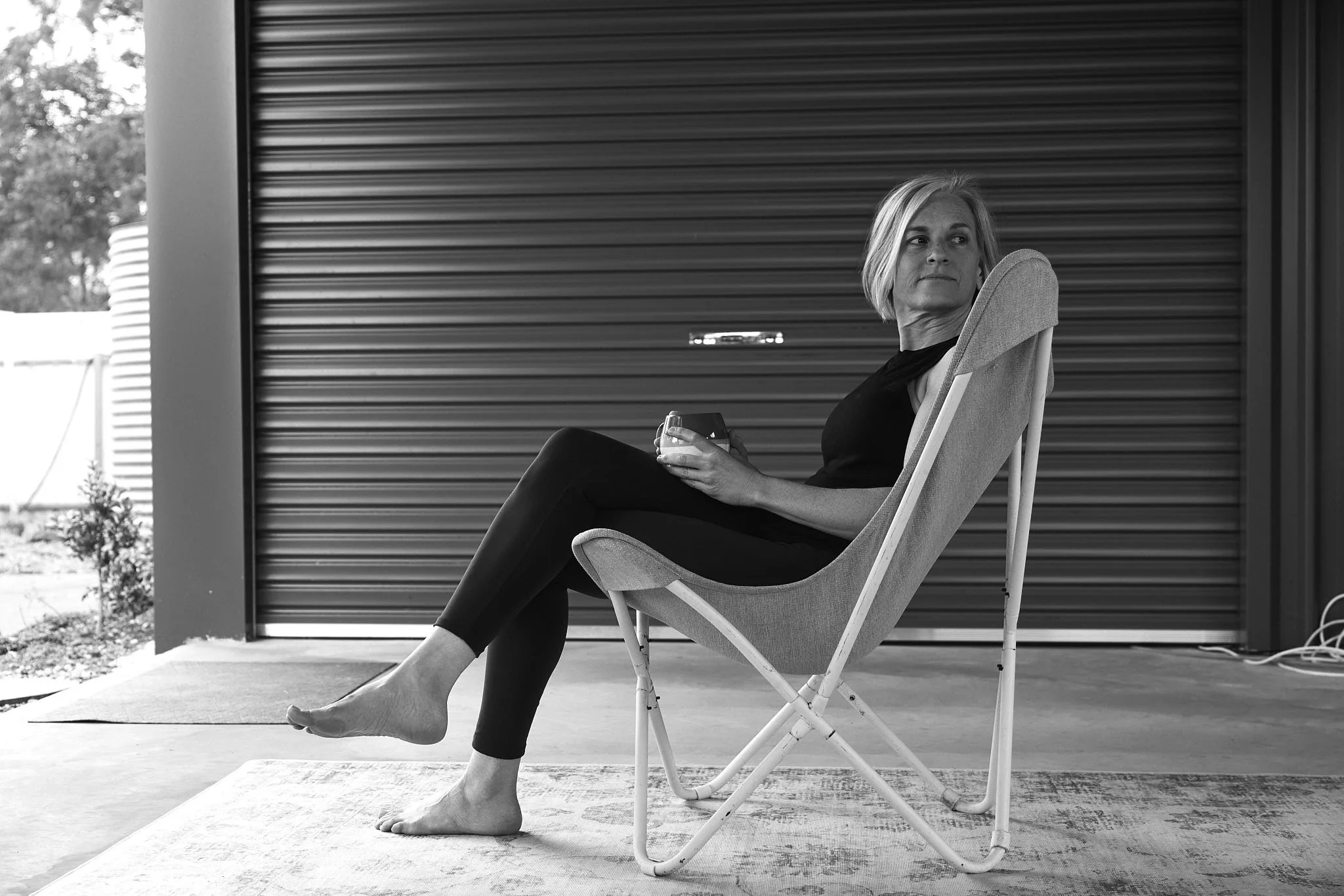 an evidence based beginner strength program for women over 40 personal trainer sitting in chair with cup of coffee