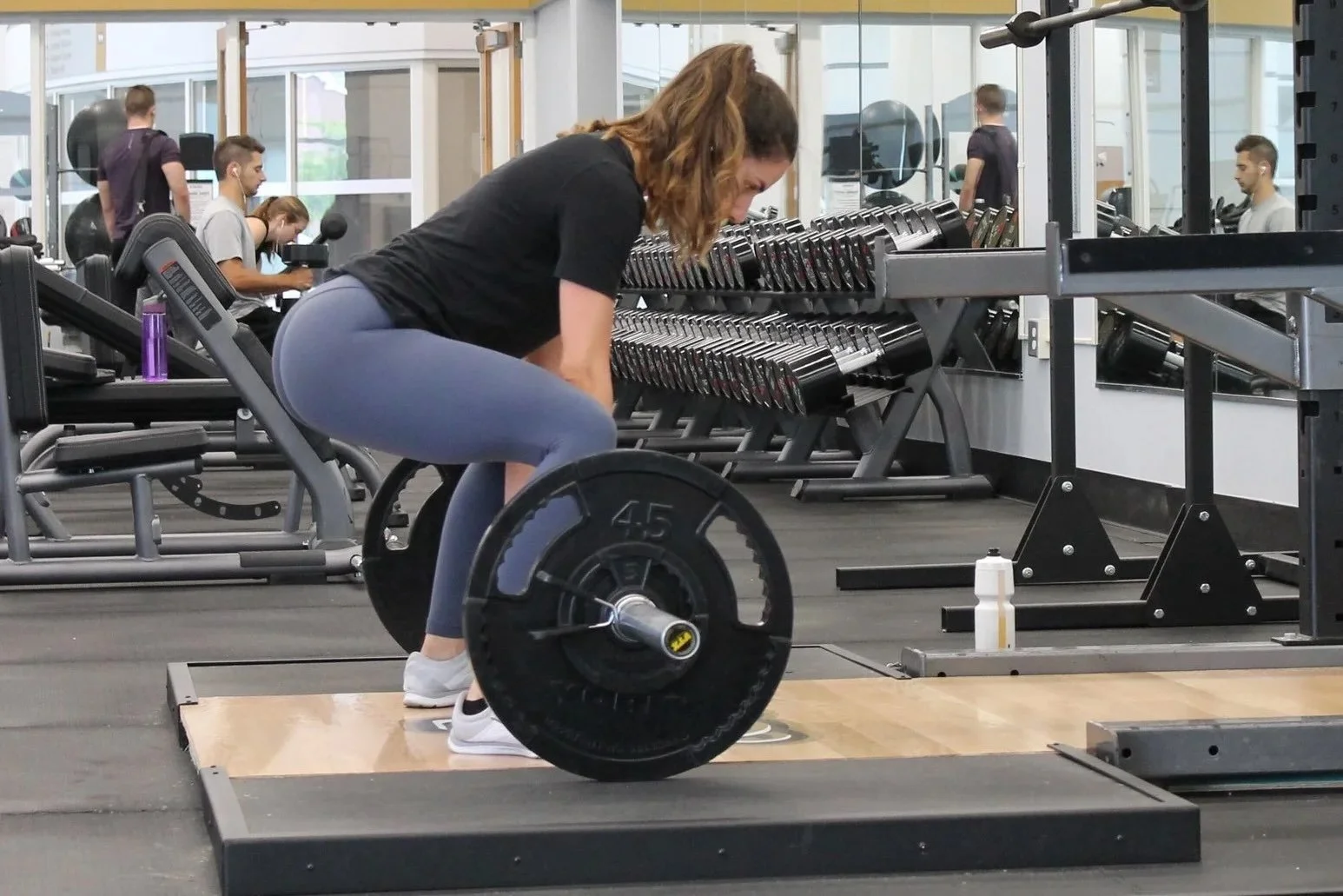a woman learning deadlift technique for strength training so she can be stronger as she ages