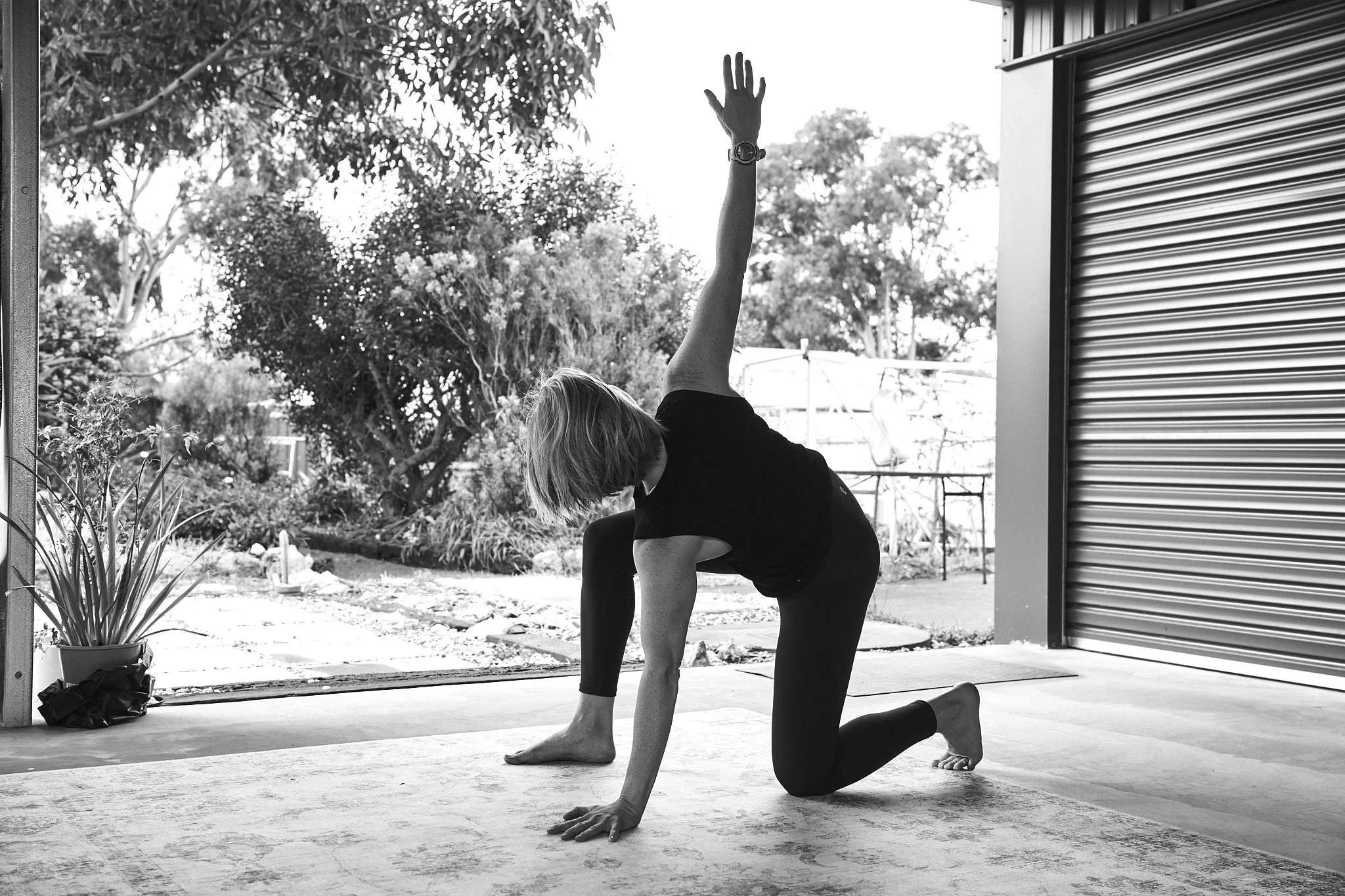 a menopausal woman showing a mobility exercise on the floor